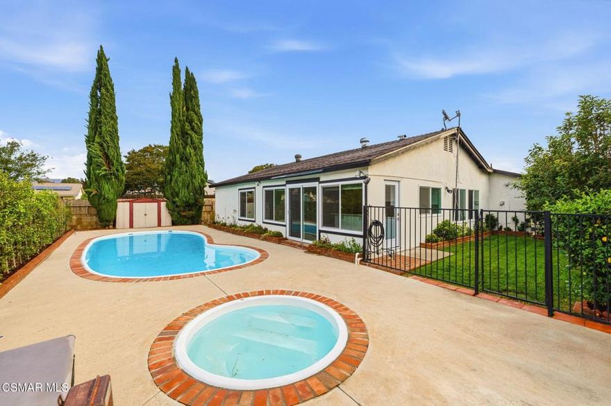 Welcome to this beautifully updated single-story pool home, perfectly positioned on a spacious, lush corner lot with mature fruit trees including avocados, lemons, limes, and apples. Nestled in a warm, inviting neighborhood just minutes from the 118 freeway and close to parks, restaurants, and shopping. Step inside to an open, airy living room that flows effortlessly into a fully upgraded kitchen.Highlights include a brand-new custom island with abundant storage and barstool seating, new quartz countertops, all-new custom cabinetry, stainless steel appliances, LED recessed lighting and all new double-pane windows. Luxury Vinyl Plank Flooring throughout, creating a modern and cohesive aesthetic. Both bathrooms have been completely remodeled with sleek, contemporary finishes. Outside, enjoy a sparkling pool and jacuzzi ideal for sunny days, gatherings, or relaxing evenings. A separate gated grassy side yard provides even more room to unwind, kids to play, or garden among the fruit trees. Security cameras included. Move-in ready and thoughtfully upgraded, this home truly offers it all.