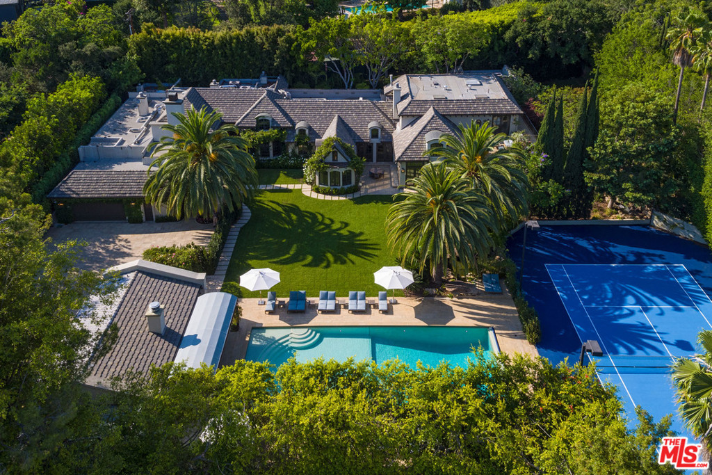 An impressive tree-lined private driveway leads to a French country estate in prime A+ location in the heart of Beverly Hills. Nine bedrooms, ten full bathrooms, four half bathrooms, on 1.14 flat acres. Main home plus two separate detached guest houses, 60 foot long resort style pool and spa, north/south facing tennis court, 15 seat home theater, surround sound systems in four additional television viewing areas, state-of-the-art fitness center, seven fireplaces, full professional bar, staff quarters. No expense was spared in this automated smart home with designer kitchen plus secondary kitchen. The extensive remodel includes handmade custom milled cabinetry with the finest details of true old-world craftsmanship blended with modern day conveniences. This turnkey estate comes loaded with every detail thought through.