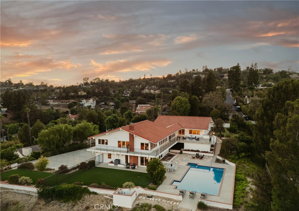 A Private Blufftop Sanctuary with Panoramic Views. From the moment you step through the front door, the view takes your breath away - and it never lets go. Every room in this home captures a different frame of the surrounding beauty.
Tucked behind private gates in Cowan Heights, this distinctive property offers sweeping, unobstructed views from every room- from Peter’s Canyon to the coastline of Fashion Island. Recently updated with designer finishes, it blends custom architecture with a calming, on-trend interior palette.
Perched on a blufftop lot, the grounds feature a saltwater pool and spa, new turf, and garden spaces ideal for entertaining or unwinding. A long driveway provides generous parking and leads to a three-car attached garage.
Inside, a dramatic vaulted foyer opens to multiple light-filled living areas and a fully remodeled chef’s kitchen with custom oak cabinetry, quartz countertops, and premium appliances, including a GE Monogram range and a Frigidaire built-in fridge/freezer.
A spacious view from the terrace with built-in BBQ extends the living space outdoors.
Downstairs, a private suite with its own kitchen, living area, bedroom, and full bath offers direct, step-free access—perfect for multi-generational living, guests, or rental use.
Additional highlights include updated bathrooms, new luxury vinyl plank flooring, and a full suite of energy-efficient upgrades: fully owned solar, new HVAC systems, LED lighting, and a smart irrigation system.
Just minutes from top-rated schools, hiking trails, and some of North Tustin’s treasured conveniences- 10181 Overhill Drive delivers privacy, versatility, and elevated North Tustin living. It’s the kind of home where the first thing you notice - and the last thing you’ll forget - is the view. Every space is designed to showcase the panorama.