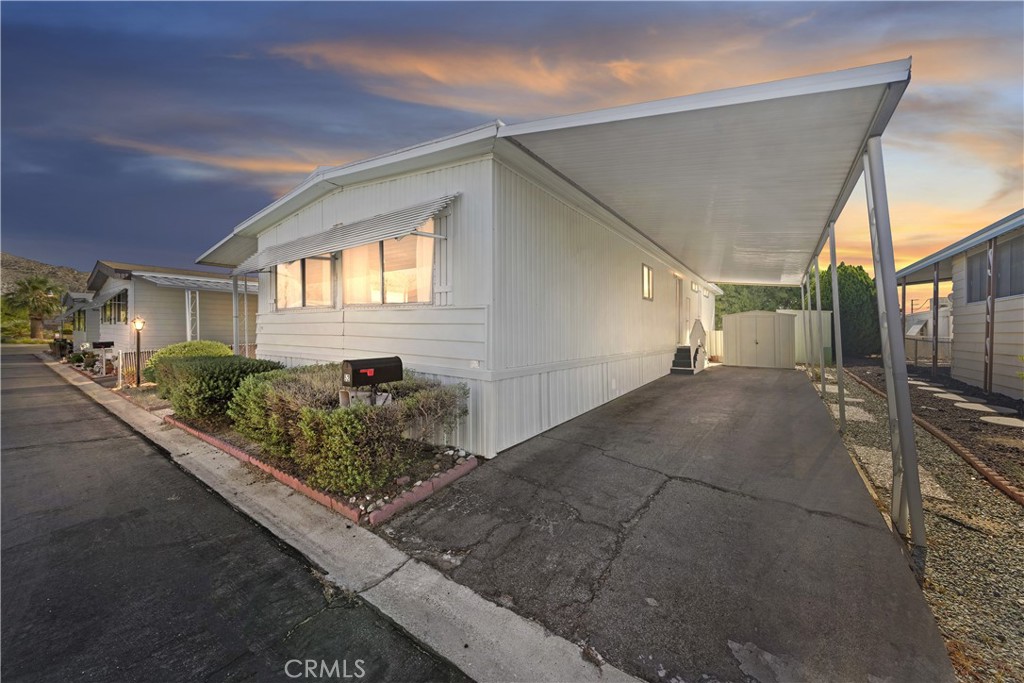 Welcome to your serene oasis in Country Club Estates, nestled in the heart of Yucca Valley's coveted 55+ mobile home community. This charming 2-bedroom, 1-3/4 bath home boasts 1,200 square feet of comfortable living space. Step inside from the front patio deck to the spacious living room with wood shutters that allow you to control the natural light. The heart of the home is the large kitchen, offering generous counter space and storage. Adjacent lies a convenient indoor laundry area. Retreat to the main bedroom suite, your private area for sanctuary and tranquility. Unwind and recharge after a fulfilling day. The second bedroom provides versatility and is ideal for guests or as a cozy den to indulge in hobbies, leisurely pursuits or perhaps as an office. Beyond the comforts of home, Country Club Estates presents a lifestyle of leisure and recreation. Situated within walking distance of Hawks Landing Golf Club, enthusiasts can tee off amidst picturesque landscapes and pristine greens. After a round of golf, savor a delectable meal at The Roost Cafe at Hawks Landing. Embrace the vibrant spirit of Yucca Valley, where natural beauty and modern conveniences await. From scenic hiking trails to eclectic boutiques and galleries, there's always something new to explore here. Whether you're seeking adventure or simply seeking solace in the serene desert landscape, Country Club Estates offers a sanctuary to call home. Don't miss your chance to experience the best of 55+ living in this coveted community. Schedule your showing today and make this tranquil retreat yours.