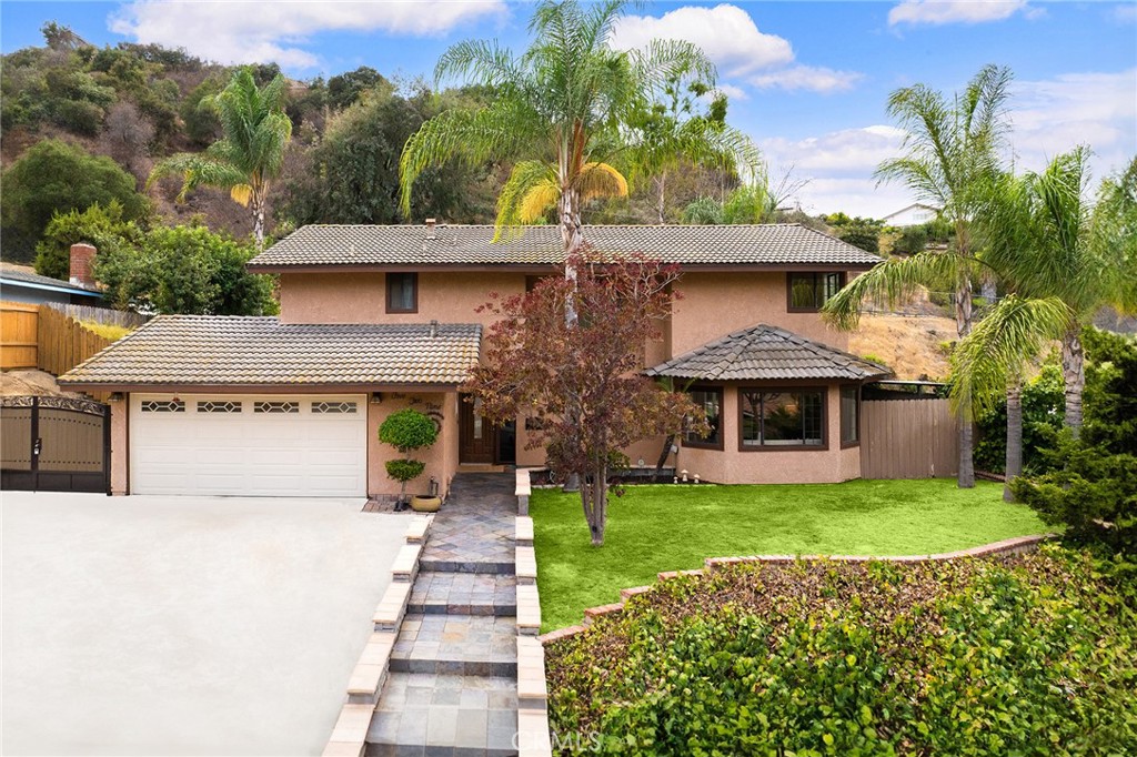 Vacation vibes in your own backyard! Welcome to 529 Bregante Drive, a private hillside retreat in the heart of Diamond Bar. This beautifully maintained 4 Bed & 3 Bath home offering the perfect balance of comfort, style, and outdoor living.
Step inside to discover a bright and inviting interior with multiple living areas, a cozy fireplace, and large picture windows framing garden and hillside views. The spacious kitchen features custom cabinetry, stone accents, stainless steel appliances, Pot Filler Faucet and a central island that flows seamlessly into the dining and family rooms—perfect for gatherings and everyday living. A bonus dedicated home office / flex space provides a peaceful environment for work or entertainment.
Upstairs, the primary suite with a full-room custom walk-in closet and a bonus office space -ideal for modern living. Features French doors that open to private balcony access, where you can enjoy sweeping mountain and city-light views. Additional bedrooms are generously sized, making this home ideal for families of all sizes.
The backyard is an entertainer’s paradise! Enjoy a sparkling pool and spa, outdoor Tiki bar, built-in fire pit, and multiple seating areas designed for relaxation or lively social events. Hillside stairs leading up to observation deck, mature trees and landscaping create a resort-like atmosphere with privacy and charm.
Additional highlights include: Gated RV Parking Space / Newly AC system /Tile Roof / Bonus Game Room/ Outside Covered Storage, upgraded finishes throughout, and a convenient location near shopping, dining, award-winning schools, and super freeway access.
This home offers not just a place to live, but a lifestyle—perfect for those who value both serenity and entertainment. Don’t miss this unique opportunity to own a hillside gem in Diamond Bar!