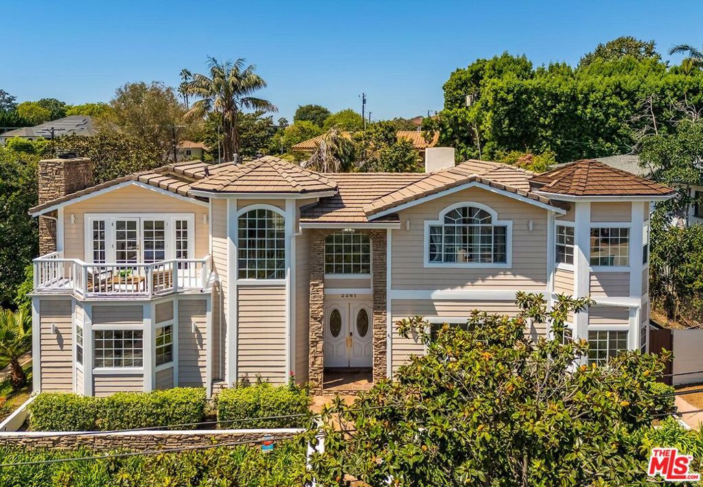Discover the epitome of California living in this gracious Beverlywood home, perfectly positioned on a spacious corner lot. This stunning 5-bedroom, 4-bathroom residence not only ensures privacy and wonderful curb appeal but also offers city views from its second story. The beautifully landscaped grounds boast a sparkling pool, a generous grassy yard, and a covered patio, perfect for entertaining or enjoying tranquil afternoons. Inside, elegance meets comfort with a thoughtfully designed floor plan on the main level, featuring a bedroom and an office that could serve as a fifth bedroom, an eat-in kitchen that flows into the dining room, a cozy sitting area, and a spacious living room. The grand entryway opens directly to the backyard, with multiple French doors inviting an abundance of natural light into the home. Upstairs, the primary bedroom boasts vaulted ceilings, a spacious walk-in closet, and an ensuite bath. Two bright bedrooms and a recently renovated bathroom complete the upper level. Additional features include a detached garage, stainless steel appliances, and fresh landscaping throughout the property. Don't miss this opportunity to own a piece of one of West LA's most sought-after neighborhoods.