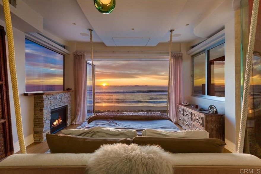 Superbly appointed and intimately customized this rare ocean front property is a unique opportunity to live the Southern California lifestyle in elegance and style. Completely remodeled to blend seamlessly with sand, sky and sea, it evokes tranquility and luxury without sacrificing direct access to some of the world’s most stunning beaches. An open concept kitchen and living area featuring an indoor spa open seamlessly to your own boardwalk patio, and an endless stretch of golden sand and clear blue water.    Featuring elegant design by Alexandra Angle and custom furniture by Peter Hansen, every space is crafted for both comfort and aesthetic appeal. The primary suite opens to a balcony directly above the iconic Mission Beach boardwalk, balancing excitement with privacy and showcasing breathtaking sunsets year-round.  Every detail was considered and no expense was spared to create a whole home integrated system of controls for ease and comfort. Featuring Miele appliances, Wolf stove, Sonos sound system, a Lutron light and shade system, individual Nest thermostats in every room, EV charging and a hardwired alarm and camera system to provide peace of mind. As you enter the main living area, an incredible array of plants hang directly through the middle of a transparent staircase and an indoor window water feature transport you to a tropical paradise. A transformed bedroom now features a full working bar, and up to 12 person home theatre perfect for entertaining or relaxing.  Whether you're biking, surfing, or simply enjoying a sunset barbecue with loved ones, this property presents an unparalleled opportunity to directly experience a piece of California's treasured beachside living.