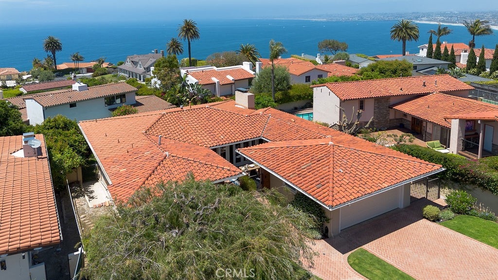 Experience the beauty and lifestyle of Malaga Cove in this meticulously crafted coastal home nestled in the heart of Palos Verdes Estates. Carefully planned with the seamless indoor-outdoor architecture that defines Southern California living, this home offers ocean views and extended living space thanks to both a private front courtyard and a spacious deck—ideal for open air entertaining or relaxing.
The light-filled living room is the heart of the home—warm, comfortable, and inviting. With hardwood floors, a fireplace, and floor to ceiling stacking, sliding doors that open to an expansive deck that brings the outdoors in, it’s a perfect space for family gatherings, entertaining or simply enjoying the ocean breeze and evening light.
The adjacent dining area flows effortlessly into an elegantly-designed kitchen with granite countertops, white cabinetry, stainless steel appliances, and a 6-burner stove that makes cooking a dream. The kitchen and dining area both offer direct access to the private courtyard, perfect for a relaxing cup of coffee or a casual outdoor meal. On the main level, you'll find the primary suite with a spacious closet and private bathroom, along with a second bedroom and a hall bathroom with dual sinks.
The lower level offers maximum flexibility with a third bedroom, an additional bathroom, a laundry room, and a den with fireplace and sliding doors to a private patio—perfect for a guest suite, media room, gym, or home office. Additional features include a 3-zone A/C system (2 condensers), updated windows and doors, and an EV charger in the attached two-car garage.
Just minutes from Malaga Cove Plaza, scenic trails, award-winning schools, and local beaches this home embodies the best of Palos Verdes Estates living—relaxed, refined, and ready to enjoy. A rare find, this property won’t last.