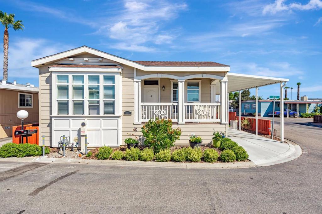 This stunning 3-bedroom, 3-bath home sits on a coveted corner lot in the desirable all-age community of Casa De Amigos. Gorgeous curb appeal welcomes you inside to a bright and elegant interior featuring 9' ceiling, coffered tray ceiling, crown molding, recessed lighting, dual-pane windows, wood laminate floors, and granite countertops. The spacious living room with a cozy corner fireplace flows into the open chefs kitchen, complete with Jenn-Air stainless steel appliances, a large island with seating, and abundant cabinetry, including tall stacked and glass-front options. The primary suite offers tray ceilings, a walk-in closet, and a private bath with walk-in shower, while a generous junior suite is perfect for guests or multi-generational living. Additional upgrades include a tankless water heater, heat pumped & air conditioner system, and added recessed lighting. Outside, enjoy the paved yard, large storage shed, spacious driveway, and side garden area. Ideally located in quiet location within the community. Near shops, parks, restaurants, Levis Stadium, VTA light rail, and easy freeway access. Dont miss the chance to own in one of the most sought-after family communities in the Bay Area! Space rent to new owners $2,250/mo.