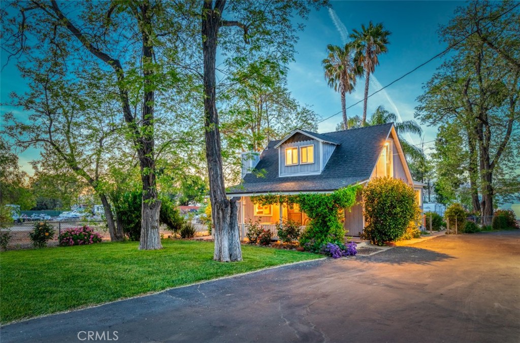 $100,000 PRICE REDUCTION!
OWN YOUR OWN PRIVATE BEACH!!
Here is a once in a lifetime opportunity to own THE cutest home on the water in Lake Elsinore! This historic 1911 cottage was meticulously rebuilt in the early 1980's under previous ownership in a manner preserving its "cottagecore" charm. Positioned on a spacious one acre lot running from Grand Ave all the way to the the lake, this super-private getaway has its own private beach and features the original 1 bedroom, 2 bath cottage as well as a detached garage with recently renovated upstairs apartment. Additionally, the 3-car garage features an attached bedroom with private bathroom and its own private patio that opens to the beautiful lawn area between the two buildings. The grounds feature majestic shade trees and a lovely variety of flowering plants. Stepping out onto the cottage rear deck you'll have commanding lake, city-lights and mountain views as you enjoy the quiet ambiance next your quaint koi pond. There is ample room on this parcel for storing boats, RV's or for possibly building an additional home as the structure is located several hundred feet from water's edge. This home is ideal for those looking for a unique home on the shores of Southern California's only naturally occurring year-round lake...a true piece of California history. Another possible use would be as a short term rental property while a caretaker could reside in the apartment above the garage. The beach features spectacular views up and down the west shore and of the surrounding mountains. You also have a very nice view of the city lights on the opposite side of the lake. Hurry, this home will not last!