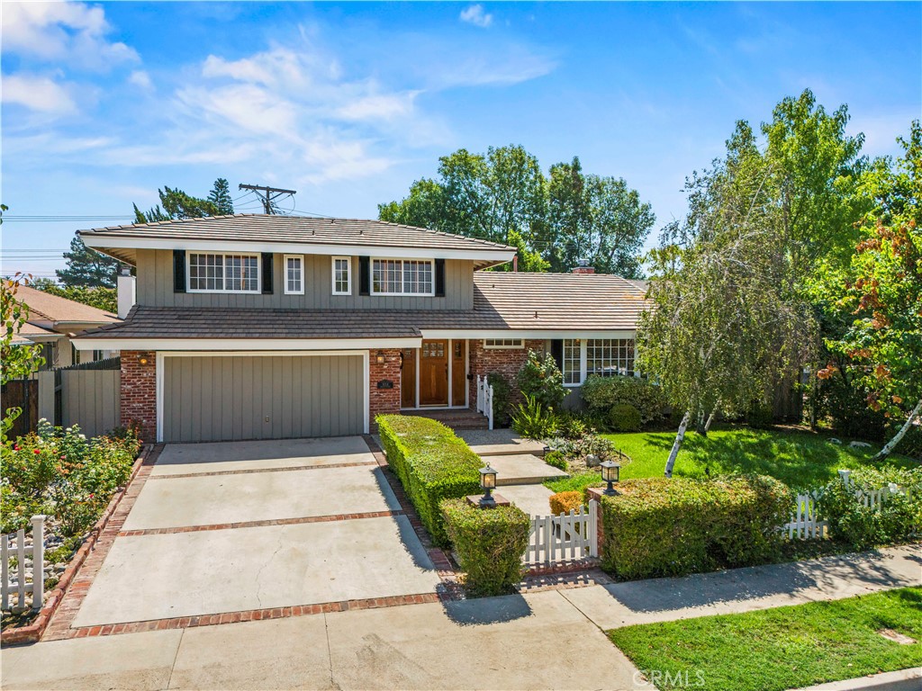 Charming Northridge Home with Storybook Curb Appeal. Welcome to this timeless Northridge residence, where classic charm meets modern comfort. From the moment you arrive, you’ll be captivated by the home’s inviting curb appeal and warm character. Step inside to a light-filled living room, where elegant French doors frame picturesque backyard views, creating a seamless indoor-outdoor flow. The bright eat-in kitchen is a chef’s delight, featuring stylish wood floors, a spacious island with extra storage, stone countertops, and custom cabinetry that blend beauty and functionality. A versatile fourth bedroom on the main level can serve as a guest room, home office, or cozy den. The converted garage offers a flexible bonus space—perfect as a game room, media lounge, creative studio, or playroom. Upstairs, the primary suite is a private retreat, complete with dual vanities, bench seating to finish getting ready for the day, a generously sized walk-in shower, and two closets with charming French-style doors. Two additional spacious bedrooms share a convenient Jack & Jill bathroom, ideal for family or guests. Outside, the lush backyard is your own private sanctuary, with mature trees, vibrant landscaping, and a large covered patio perfect for relaxing or entertaining year-round. This home effortlessly combines character, comfort, and functionality—ready for you to move in and make it your own. Schedule your private showing today and experience its charm firsthand!