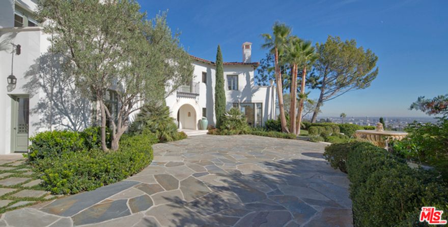 Rare opportunity to acquire Tim Morrison's latest architectural triumph. Spanish Revival estate captures soul & spirit of California's most prestigious homes built during Golden Age of Architecture. N of Sunset in prime Beverly Hills & situated at the end of a long driveway on a private promontory, this estate overlooks breath-taking views from Ocean to Downtown & captures pastoral views of Hills & Franklin Canyon. Property is finished in the finest quality & taste, with excellent space & scale, & spectacular uses of marble finishes. Main residence includes superb master with incredible views, sitting rm, dual baths/dressing rms. 3 additional bdrm suites complete top floor. Lower level offers chef's kitchen with eating area, butler's pantry, family rm, formal living & dining rms, study, guest suite & maids. Guesthouse with large bdrm suite. 3-car garage & ample space for parking in motor court. Private & lush grounds feature gorgeous shell shaped pool & decks, with stunning views.