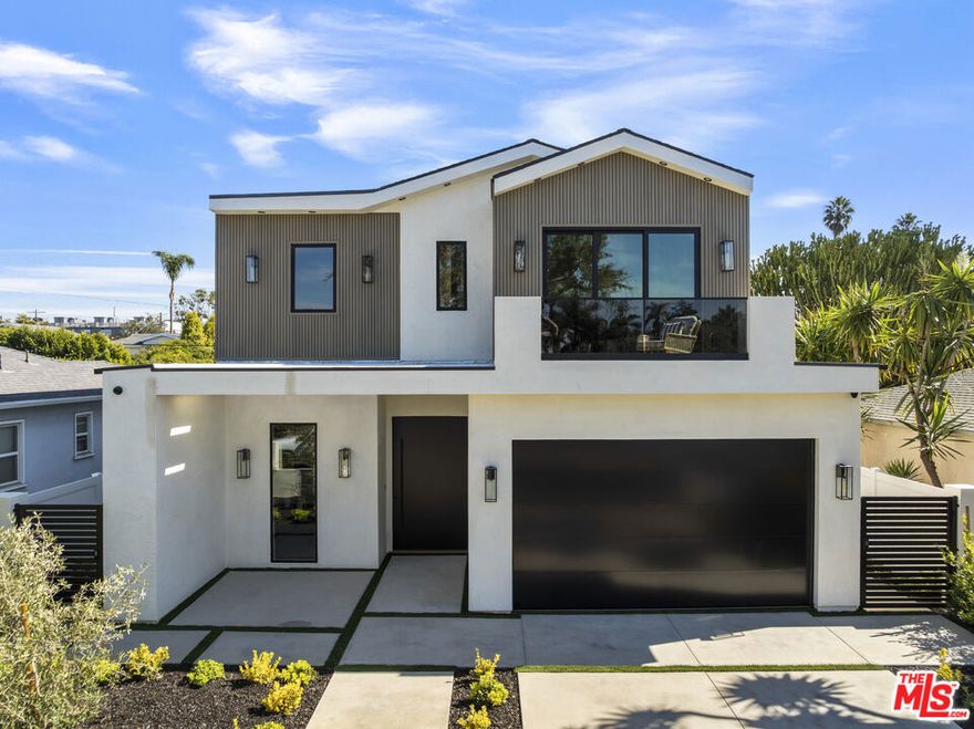 Welcome to 4220 Kenyon Avenue, a newly built modern masterpiece in the heart of Del Rey. Behind its gated facade, this home blends refined sophistication with effortless California coastal living. Inside, wide-plank European oak floors and soaring ceilings flow through an open layout centered around a sleek fireplace and floor-to-ceiling porcelain feature wall. Custom pocket doors open to a private entertainer's paradise complete with a sparkling pool and spa, built-in barbecue, outdoor speakers, and drought-tolerant landscaping. The chef's kitchen impresses with custom cabinetry, leather-finish Taj Mahal countertops, and high-end appliances. A first-floor bedroom provides ideal flexibility for guests or a home office. Upstairs, the vaulted primary suite features a fireplace, private balcony, illuminated closet cabinetry, and a spa-inspired bath with dual sinks, freestanding tub, and large shower. The 400-square-foot ADU offers a kitchenette and full bath, perfect for guests, a gym, or creative space. Thoughtful details include solar panels, a DoorBird intercom system, hard-wired security, dual-zone HVAC, and an EV-ready epoxy-floor garage. Ideally located near Marina del Rey, Playa Vista, and the Westside's best dining and beaches, this home embodies modern California luxury at its finest.