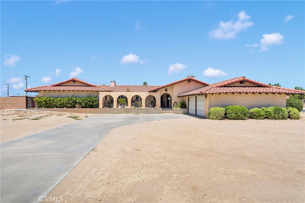 This 4 bedrooms 4 bathrooms pool and spa home blends generous space and timeless charm. Situated in a nearly 1 acre corner lot. Gated front courtyard with lush floral landscaping and a stoned-lined pond with a gentle flow of water offering an inviting retreat for tranquil morning or evening relaxation or gatherings with family or friends. Nestled on the corner of Choco Rd and Red Feather Rd, this magnificent home offers about 3100 square feet of living space. Step into a beautiful designed living area featuring an open concept layout that seamlessly blends comfort and sophistication. 4 good size bedrooms, two of the bedrooms have a fireplace. Home offers 2 full bathrooms and 2 half bathrooms. The living room is anchored by a striking floor to ceiling rock fireplace. The large windows and sliding glass doors bring in natural light and serene views of the backyard. The expansive kitchen offers generous counter space, and upper and lower cabinets making it convenient for organizing and storing your kitchen tools. Laundry room offers easy laundry chores with cabinets and it's own sink. The backyard features a large size inground pool and spa surrounded by lots of concrete, green grass and beautiful flowers. The little ones will have tons of fun in the pool and patio. There’s a half bathroom inside the garage with direct access from the pool area. There is also a storage room that adds additional convenience with access to the garage. All this plus a large portion of the lot is private, fenced and gated where you can keep all your toys! There is RV access/RV parking that is fenced and gated for privacy, Tons of space to build a ADU as second home. A lot of parking for trailers RVs and other large vehicles. Everything inside this home is beautiful and inviting, Outside is a paradise too, this property will not last and is highly recommended that you schedule your appointment to see with your Realtor of choice.