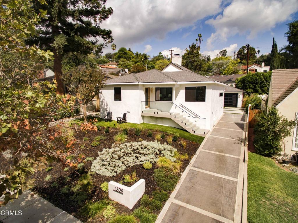 Dramatic and sophisticated, this modern treasure in the San Rafael Hills embodies timeless design and effortless livability. Originally built in 1948 and beautifully reimagined inside and out, 1525 La Loma Road feels entirely new while retaining the integrity of its mid-century roots.A light-filled, open floor plan unfolds with an elegant great-room concept, where the living room, anchored by a sleek gas fireplace, flows seamlessly into the dining area and a striking custom kitchen. Crafted with precision and artistry, the kitchen features hand-stained oak cabinetry, designer surfaces, and premium appliances, offering both beauty and performance. Smooth-coated walls, contemporary tile flooring, and tailored lighting create an atmosphere of quiet sophistication throughout.The primary suite opens directly to the gardens and features a newly added, spa-inspired three-quarter bath with floor-to-ceiling tile and a walk-in shower. Two additional bedrooms share a beautifully appointed three-quarter bath, providing flexibility for guests, a home office, or creative pursuits.Curated low-maintenance landscaping and an expansive private patio set the stage for intimate gatherings or tranquil evenings under the stars. This San Rafael Hills residence is as sophisticated as it is livable, a true move-in-ready retreat.