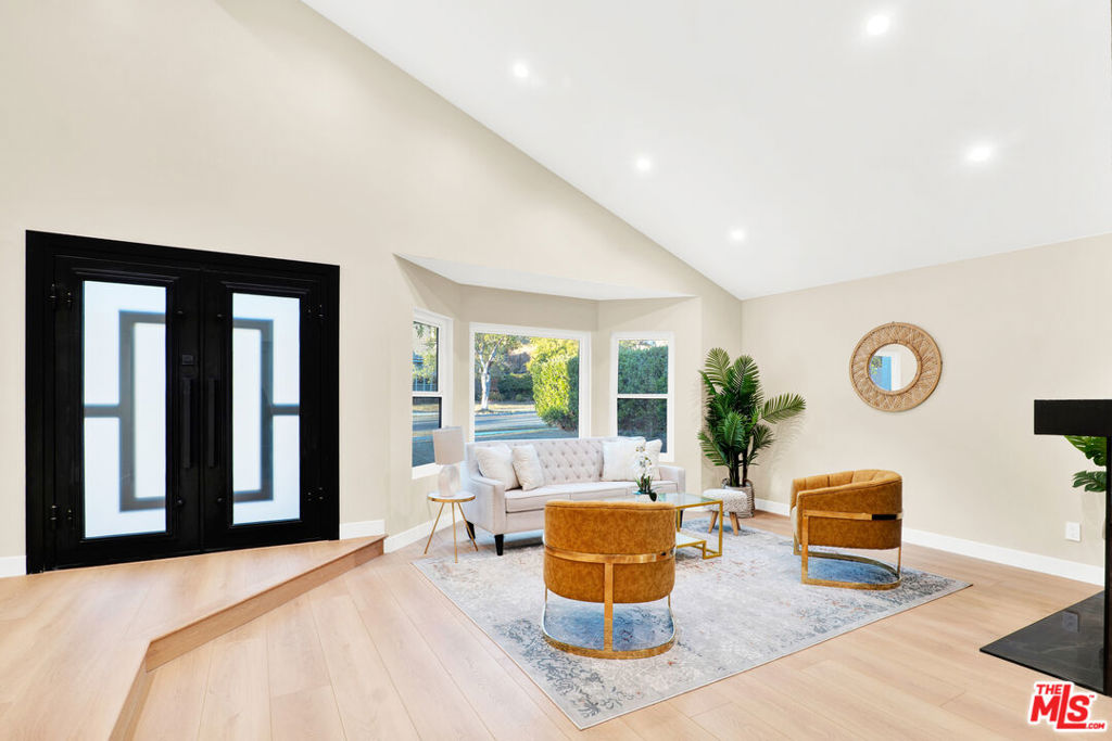 Experience elevated living in this beautifully remodeled 4-bedroom, 3-bathroom home, perfectly situated on a quiet cul-de-sac with stunning views. Thoughtfully redesigned with exceptional attention to detail, this residence blends modern elegance with timeless comfort. Every inch of the home has been updated with high-end, designer-selected finishes and materials, creating a sophisticated yet inviting atmosphere. The open-concept floor plan features spacious living and dining areas, ideal for both entertaining and everyday living. Large windows and sliding glass doors illuminate the home with natural light and frame the expansive views. The gourmet kitchen boasts premium appliances, custom cabinetry, and sleek countertops. The primary suite offers a serene retreat, complete with a luxurious en-suite bathroom and walk-in closet. Three additional bedrooms provide flexibility for family, guests, or a home office. Enjoy serene outdoor living with breathtaking hillside views stretching across Burbank, the San Fernando Valley, and Downtown Los Angeles. This turn-key residence offers the ideal combination of privacy, modern luxury, and convenience in one of Burbank Hills' most sought-after neighborhoods.