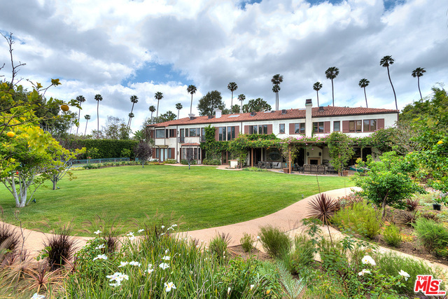 Distinguished 10,000+ square foot Mediterranean style residence designed by architect Peter Choate, available for only the second time in over 60 years. Extremely rare double lot of approx. 1.2 private, park-like acres in the heart of the Beverly Hills flats. Property includes a guest house, swimming pool, lighted sports court, large gated courtyard entry with magnificent trees and fountains. Open plan interior with lustrous wood floors and wide views onto tranquil gardens. Gorgeous exposed-beam living room; formal dining with coffered wood ceiling; handsome great room with dramatic double-height truss ceiling, fireplace, wet bar, loft. Entertainer's kitchen has breakfast area, center island, stainless appliances, and butler's pantry. Private screening room has hand-painted ceiling. Glamorous master with fireplace, palatial baths, walk-in closets. Gym with private bath and sauna. Majestic yard has fruit trees, rose garden, broad lawn, and flowering vines. A masterpiece of refined style