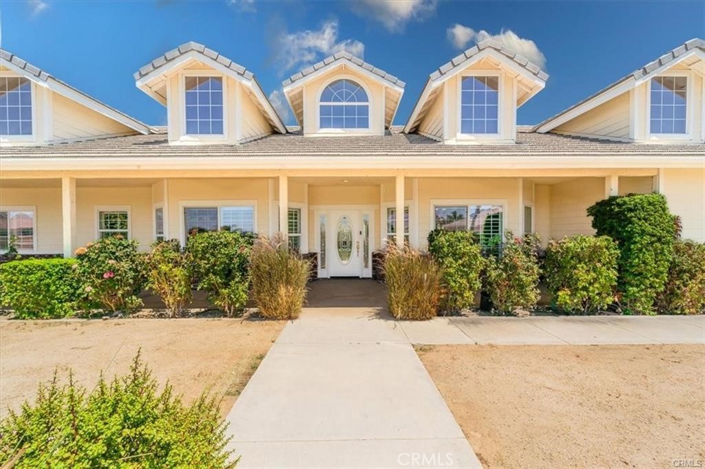 Charming custom-built pool home on a spacious corner lot in beautiful East Hemet! Set on nearly half an acre of flat, usable land, this home offers serious curb appeal and a backyard made for entertaining. Enjoy warm evenings on the inviting covered front porch, perfect for soaking in stunning sunsets. The backyard features a sparkling pool, covered patio, and extensive hardscaping with boulders, brickwork, and concrete finishes ideal for gatherings with family and friends. Inside, the grand foyer greets you with soaring 20-foot ceilings. The separate living room features a cozy wood-burning fireplace and plantation shutters that add style and warmth throughout. The expansive kitchen boasts granite countertops, a large center island, walk-in pantry, and French doors leading out to your private outdoor oasis. A formal dining room with a bay window creates the perfect setting for special meals. The primary suite is its own retreat, complete with a luxurious walk-in shower, freestanding soaking tub, dual vanities, his and hers walk-in closets, and direct access to the pool area. Additional highlights include a three-car garage with direct access, an indoor laundry room, and a gated area that may offer RV parking or even potential for an ADU (buyer to verify with the City of Hemet). This exceptional home is move-in ready and full of possibilities. Schedule your showing today, at this below market price we are not expecting this one to last!