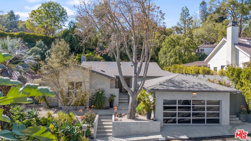 New Price!! Turnkey midcentury home located on one of the best and quietest streets in Upper Nichols Canyon. Centrally located just minutes away from the Studios and the Sunset Strip! This home features an open floor plan with a wall of sliding glass doors that open from the dining room and large living room to a completely private backyard that is perfect for outdoor entertaining. The kitchen has commercial grade appliances including a cappuccino maker and opens to the expansive family room. There are wide plank oak floors throughout. The primary suite has a large walk-in closet, private outdoor courtyard, and a luxurious bath complete with a soaking tub. There are two more bedrooms and 3 full baths- all finished in natural stone. A separate laundry room, skylights throughout and a two-car garage with direct access to the gated entry courtyard. The property features a central sound system and exterior security cameras. This unparalleled property is gated and private and is on a cul-de-sac in one of the best neighborhoods in the Hollywood Hills. Best price per square foot for a spotless, turnkey home in the Hollywood Hills!