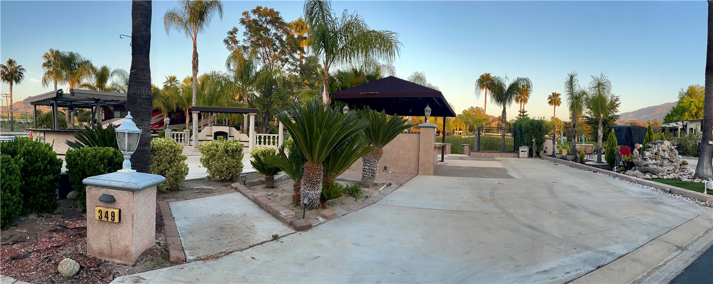 Site 349 is a great location, just two sites away from the largest club house. The largest pool in the resort along with a jacuzzi is to the back side of the club house. This club house has a ping pong table and pool table inside along with other amenities. There are tennis courts and pickle ball courts near by. The best feature of this location is the amazing view of a golf course lake and the beautiful golf green just on the other side of the lake.While sitting on the patio at this site you can look down the long Fairway out to the beautiful green Palomar mountains. The front of the property has a well landscaped side yard. Parking for a golf cart is nestled in this area amongst the lush green tropical plants. Just beyond is a large kitchen. Here you will find considerable counter space and a kitchen island with seating on one side and considerable storage cabinets underneath. There are two refrigerators, a separate freezer and additional storage cabinets under the counter. The double sided stainless steel sink with hot and cold water has a garbage disposal. In addition to a smaller brick patio on the front side of the property, there is a large patio area just outside the kitchen. A low seating wall runs across the entire back side of this patio area.There is a step down section in this area covered by a gazebo.
