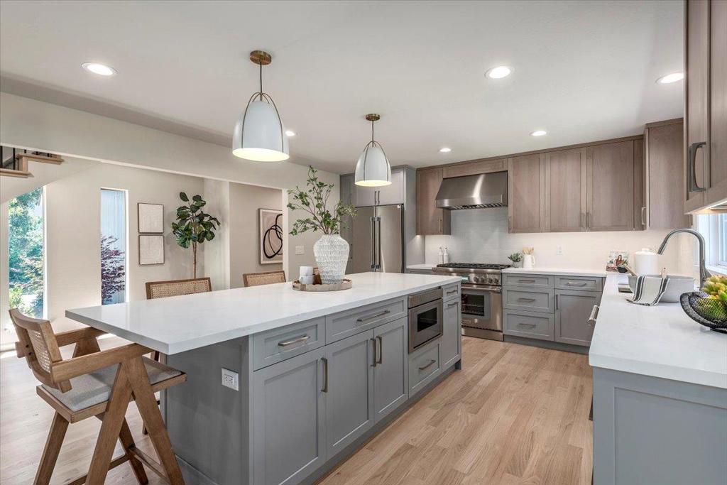 Located on a quiet cul-de-sac in the Alta Heights area, this 5-bedroom, 2.5-bath home offers direct access to Worcester Park and is just minutes from Downtown Los Gatos. The home is set on nearly half an acre (19,133 sq ft) with mature trees, greenbelt views, and nearby nature trails. Inside, the open-concept layout features vaulted ceilings, oak hardwood floors, large picture windows, and custom built-ins. The living room features a stone wood-burning fireplace, and the family room, also equipped with a fireplace, opens directly onto the landscaped backyard. (Plans available for adding a full bathroom to the family room, allowing for an additional ground-level primary suite.) The remodeled kitchen includes a large center island, Thermador stainless steel appliances, a gas range, new cabinetry, and a dining area with abundant natural light. Upstairs, the primary suite features sliding doors that open to the back deck, a walk-in closet with custom organizers, and an en-suite bath equipped with dual sinks, a walk-in shower, tile flooring, and smart medicine cabinets. The backyard is designed for entertaining, with a spacious deck, outdoor kitchen, built-in firepit, and hot tub, all surrounded by mature landscaping and privacy.