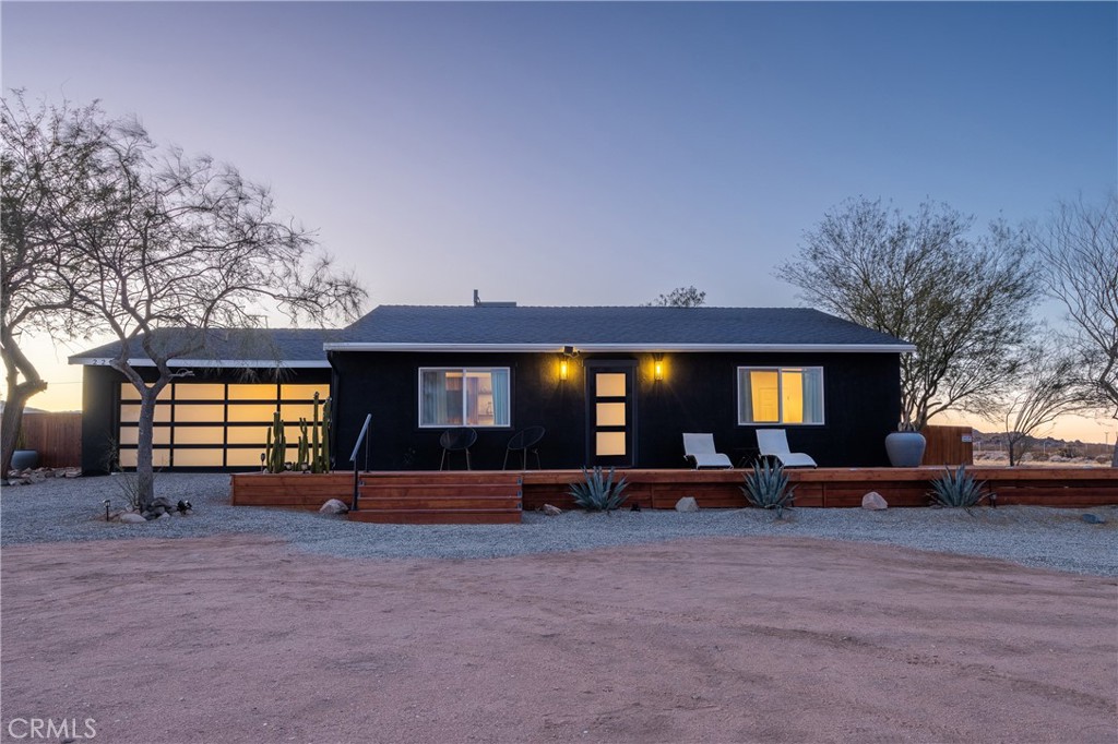 Experience true pease under the sun and stars at this tastefully designed home in landers with virtually no immediate neighbors. Landers is located in northern portion of the Joshua Tree Gateway communities and is known for its isolation from noise and light pollution resulting in Darkest Nights and Quietest Days. Near landers own series of attractions like Giant Rock, Goat Mountain Hikes, The Black Lava Butte Preserve and the Inegratron. This home sit elevated on its lot enhancing the Views to the northeast and South from large windows. The interior of this home features a large living room for lounging and listening to records while enjoying the warm glow of the fireplace. The Kitchen features ample counter space, Modern appliances and kitchen window views and adjoining dinning space. 2 Large Bedrooms with windows and Access to the Bathroom. The Bathroom is large and designer tile in the walk in shower. The backyard is fully fenced featuring a Spa, an outdoor shower, and a fire pit. The front of the house Features a large Deck with chase lounges for enjoying the sweeping views and morning sun and evening moonrise. The living garage's glass door creates a perfect indoor outdoor space for enjoying the deserts blessed evening weather while enjoying film and is Air conditioned. Included in the sale is a Large 'Tiny' home located on the property which features a deck, kitchen, living room, 2 queen beds and 1 bathroom