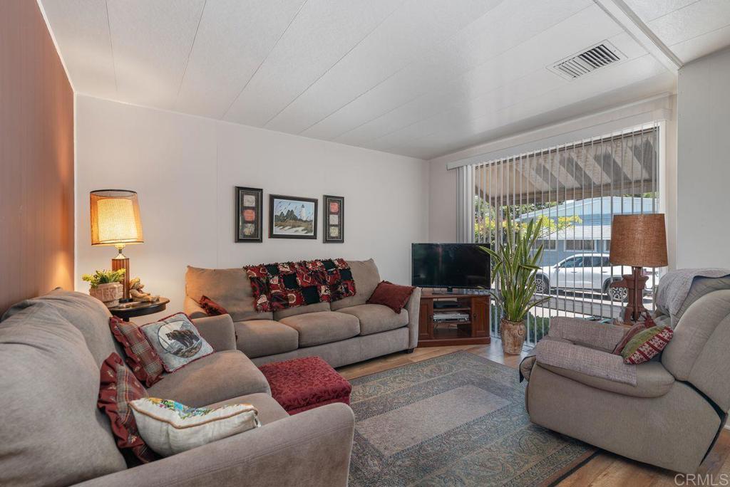 Back on market at no fault of home! Buyer could not perform. Updated and meticulously maintained, this very affordable manufactured home is located on a quiet lot away from street noise in this 55+ park. In the kitchen you will find a newer cooktop, oven and microwave, and newer sink and faucet. Baths are updated with newer shower heads and lighting, newer tub surround in hall bath. Laminate flooring in bedrooms and living areas, vinyl flooring in wet areas. Lots of storage throughout the home, along with a newer storage shed in the carport area. Space Rent is $775/month plus water, sewer, recycle fee. Commmon area has 2 pools, spa, clubhouse, billiards, and many activities.