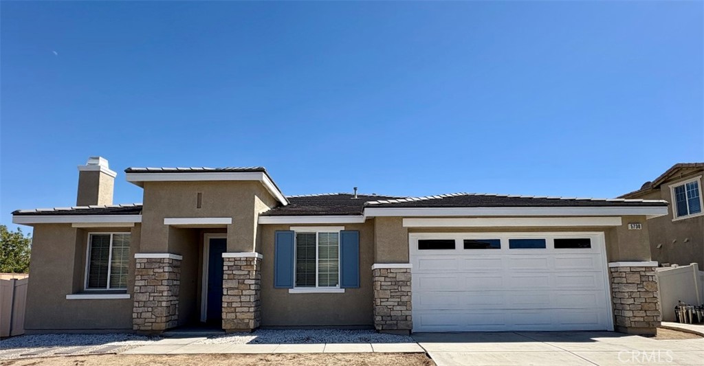 This beautiful one-story home in East Palmdale offers 4 spacious bedrooms and 3 full bathrooms across approximately 2,108 square feet of living space. Inside, you'll find both a formal living room and a family room, each equipped with its own fireplace—perfect for relaxing or entertaining. The home features a large, open kitchen with granite countertops, a center island, and plenty of cabinet space. Each bathroom is equipped with a built-in humidifier for added comfort. The single-story layout provides easy access throughout the home, and the property includes a spacious 2-car garage with additional driveway parking. Move-in ready and located in a quiet, convenient neighborhood near major retail centers, this well-maintained home offers both comfort and functionality.