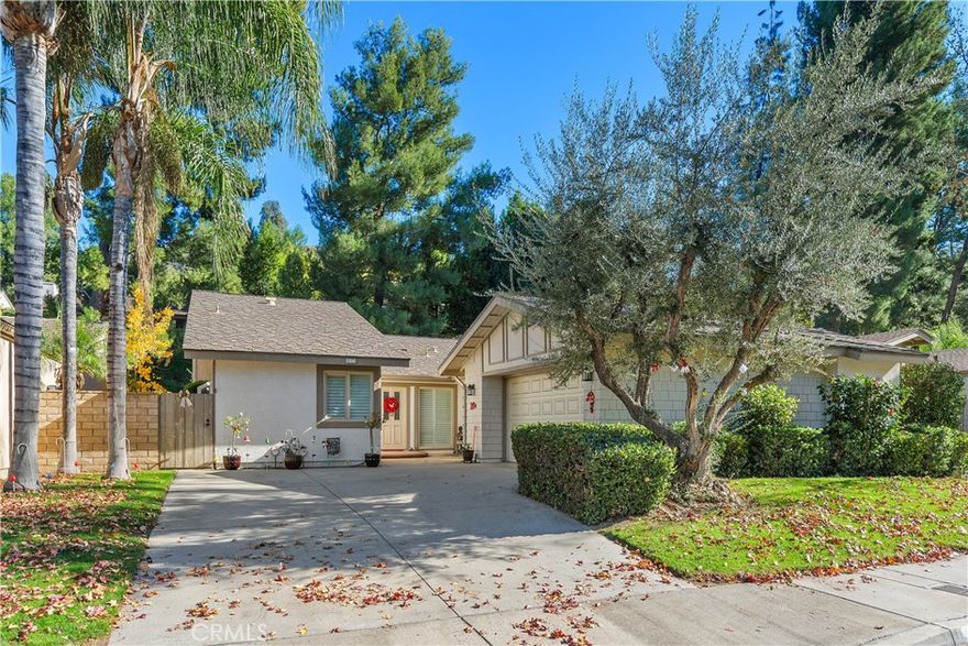 Discover the allure of Canyon Hills, a highly coveted community of only 62 homes tucked against the beautiful Sycamore Canyon hills. Ideally located in Riverside, you're just minutes from UCR, the Canyon Crest Town Center, and convenient transportation.
Step inside this courtyard-entry home to be greeted by a dramatic, open living space featuring vaulted ceilings, elegant crown molding, and custom wood shutters throughout. The centerpiece is a cozy crystal rock gas fireplace, surrounded by plenty of natural light.
The kitchen has been beautifully updated with French Country cabinetry, stone quartz counters, upgraded appliances, and a bright garden window. The kitchenette eating area features sliding doors leading to the side yard patio, perfect for outdoor dining.
The home's layout is practical and well-appointed. Bedroom #1, positioned near the front courtyard, offers a spacious closet. Further down the hall, you'll find custom linen cabinets and the hall bath, which features a full tub/shower combo and natural light from a solar tube. Bedroom #2 includes views of the back patio and a convenient walk-in closet. The main bedroom is a spacious retreat with a vaulted ceiling and direct patio access. Indulge in the spectacular main bathroom, showcasing a walk-in shower with a skylight and a custom quartz counter that is dramatically lit from beneath.
Enjoy the low-maintenance outdoor space with multiple private patios and pathways, a lush, private hillside backdrop, and artificial grass. The indoor laundry room provides a sink and storage, and the garage offers extensive cabinet storage. The community pool, spa, and clubhouse are conveniently located just one door down. This home perfectly blends luxury and convenience—come see it today!