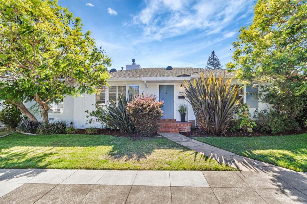 Nestled in picturesque White Oaks neighborhood, the beautiful single-family home combines modern appeal with classic details to create a truly inviting living space. The living room is a standout, offering a fireplace, elegant tray ceiling, and large picture window, with natural light, creating a warm and inviting atmosphere. Adjacent to the living room, the spacious dining area also features a picture window, perfect for enjoying meals with a view. Sunny eat-in kitchen provides a bright space to cook and gather. Two generous sized bedrooms offer comfortable retreats. Step outside, you'll find a thoughtfully landscaped area that embodies the spirit of wine country entertaining. Featuring flowering plants, lawn and pebbled dining with built in benches for your outdoor enjoyment, and a private courtyard with a built-in fireplace and BBQ, it's an ideal space for hosting gatherings or simply relaxing in the tranquility of your surroundings. Additional features include freshly painted inside and out, central heating, interior laundry, and oversized 1 car garage. A short stroll from downtown San Carlos' shops, restaurants, and parks, plus convenient access to Caltrain and commute routes, this home offers the perfect mix of comfort and convenience. Make this charming gem yours today!