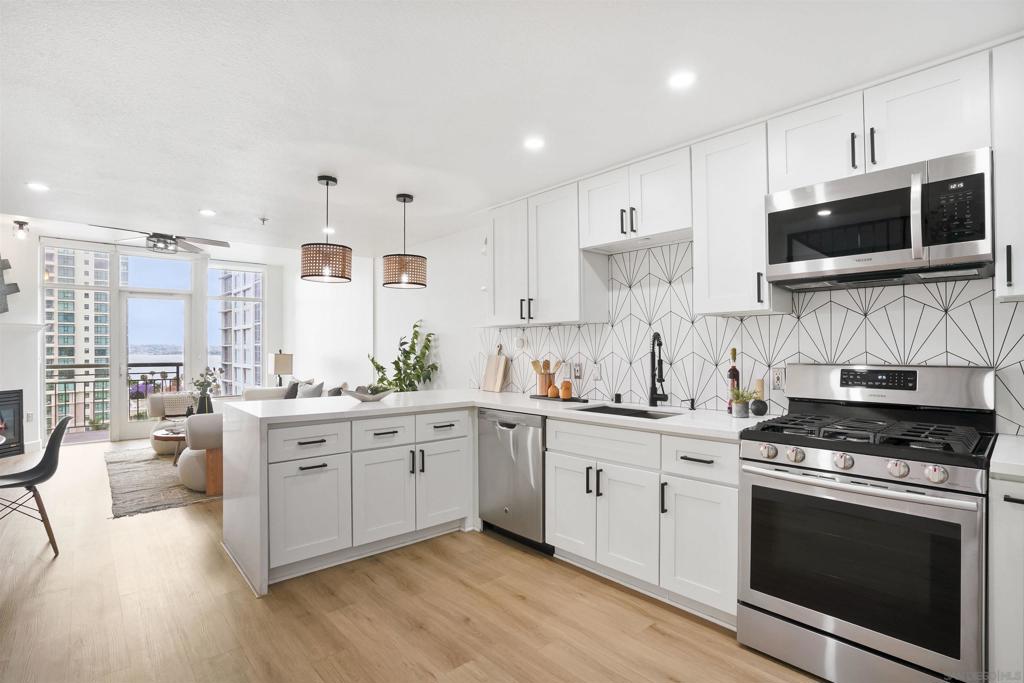 Fully remodeled 2BR/2.5BA condo with stunning bay views in the heart of Little Italy. Located on the 11th and 12th floor of Treo, this upgraded residence features an expanded custom kitchen with stainless steel appliances, gas range, and designer finishes throughout. All bathrooms have been tastefully renovated, and the unit includes wide-plank hard surface flooring, upgraded lighting, and a modern open-concept layout that maximizes natural light and livability. Treo is a full-service high-rise offering concierge, 24-hour security, a pool, spa, fitness center, amenity room, and BBQ areas—all ideally situated near Waterfront Park, Seaport Village, and the world-class restaurants and shops of Little Italy. This unit includes two assigned parking spaces and an additional storage unit, offering rare convenience in one of downtown’s most desirable buildings. With HOA dues significantly lower than other luxury buildings nearby, Treo delivers exceptional value without compromising on amenities or location. Experience the best of coastal urban living with sweeping bay views and walkable access to all that downtown San Diego has to offer.