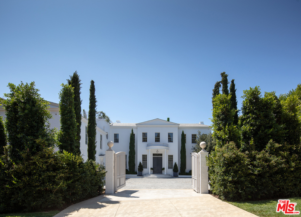 An extraordinary gated estate in one of Brentwood's most desirable enclaves, 227 N. Tigertail showcases a masterful fusion of striking, traditional elegance and chic, contemporary vision. The Windsor Smith-designed interiors feature a stunning palette of grey, white and dark ebony hues, detailed parquet wood floors, intricate stonework, and soaring ceilings. Arched doorways provide an effortless flow between living & entertaining spaces, while floor-to-ceiling French doors and clerestory windows draw the outdoors in. The home boasts a magnificent chef's kitchen, master bedroom suite with dual marble showers, soaking tub and fireplace, a rooftop terrace for dining and lounging, a zero-edge swimming pool, yoga room, detached 1-bdrm pool house and separate 1-bdrm pavilion w home theater. An exemplar of classically inspired, contemporary design vision, Tigertail is an ultra-private, tranquil escape within minutes of world-class restaurants, shops, & entertainment.