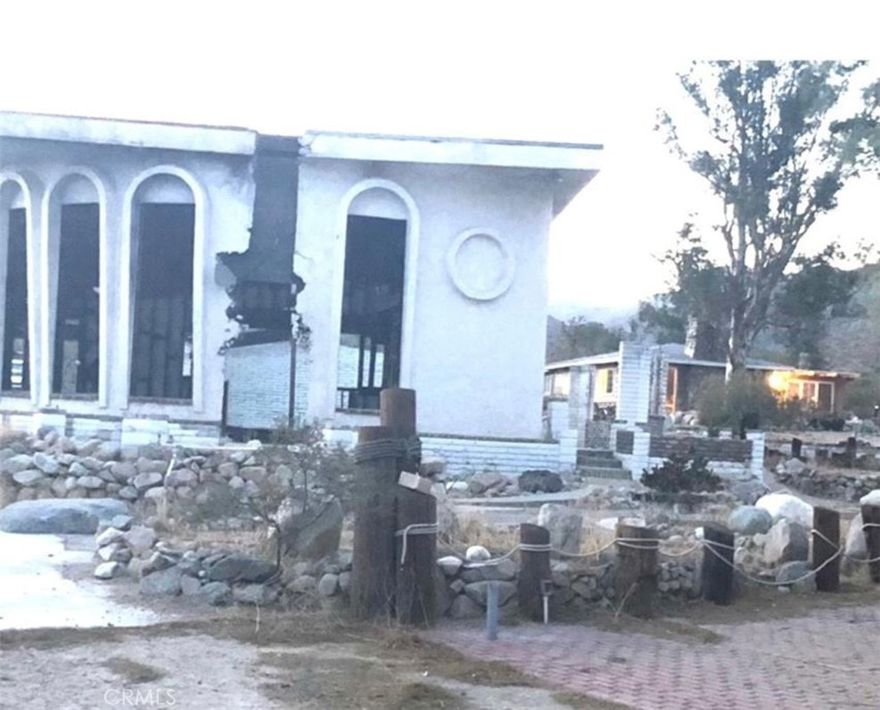Great fixer-upper opportunity for investors. House is partially burned, Separate 2 car garages are untouched and have new roofs. One separate studio is untouched and next to it has a green house.

The added living room is partially damaged. Irrigation pluming is intact but the house needs new plumbing and electrical. Stamped concrete and concrete driveway all around. Concrete wall surrounds the property.