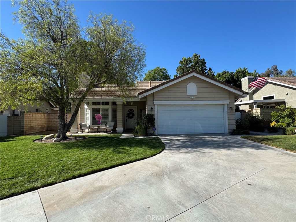 Don’t miss this rare opportunity to own a charming single-story home in the highly sought-after Northbridge community of Valencia! Nestled at the end of a quiet cul-de-sac in the Country Gate neighborhood, this meticulously maintained 2 bed, 2 bath home sits on an expansive nearly 8,000 sq ft lot—offering ample room for future expansion and large outdoor entertaining. Find brand-new flooring throughout with LVP wood flooring in the main living areas and carpet in the bedrooms, along with fresh neutral interior paint. The light and bright living room features a custom stone fireplace, recessed lighting, plantation shutters, and a new custom built-in for added storage. The kitchen has granite countertops, neutral painted cabinetry, and a sunny garden window with views of the beautiful manicured backyard. The adjacent dining area is perfectly situated for everyday meals and entertaining. The primary suite offers a wall-to-wall closet, a large slider with direct access to the backyard patio, a reglazed shower, and a stylish sliding barn door for bathroom privacy. The secondary bathroom includes a skylight, and the indoor laundry room adds everyday convenience. Outside, enjoy a large private backyard with mature trees and landscape, refreshed patio cover, a concrete patio that wraps around 3 sides of the house for plenty of space for outdoor furniture and social gatherings. The adorable pavered front porch with a covered entry adds to the home’s curb appeal. You’ll love the attached 2-car garage with built-in cabinets providing ample storage with additional storage in the attic. Never worry about parking with an oversized driveway that easily accommodates four cars. Additional updates include new lighting fixtures in the entry and dining room, new interior door hardware, and ceiling fans in the living room and both bedrooms. One of the greatest features of owning this home is the access to the endless HOA amenities, including three pools, spas, a clubhouse, basketball and tennis courts, and scenic paseo trails leading to award-winning schools, nearby shopping, and restaurants. This home truly checks all the boxes—location, lifestyle, and comfort. Schedule your showing today!