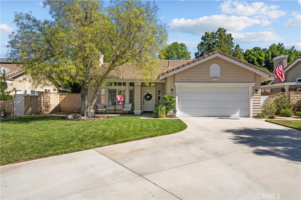 Don’t miss this rare opportunity to own a charming single-story home in the highly sought-after Northbridge community of Valencia! Nestled at the end of a quiet cul-de-sac in the Country Gate neighborhood, this meticulously maintained 2 bed, 2 bath home sits on an expansive nearly 8,000 sq ft lot—offering ample room for future expansion and large outdoor entertaining. Find brand-new flooring throughout with waterproof laminate wood flooring in the main living areas and carpet in the bedrooms, along with fresh neutral interior paint. The light and bright living room features a custom stone fireplace, recessed lighting, plantation shutters, and a new custom built-in for added storage. The kitchen has granite countertops, neutral painted cabinetry, and a sunny garden window with views of the beautiful manicured backyard. The adjacent dining area is perfectly situated for everyday meals and entertaining. The primary suite offers a wall-to-wall closet, a large slider with direct access to the backyard patio, a reglazed shower, and a stylish sliding barn door for bathroom privacy. The secondary bathroom includes a skylight, and the indoor laundry room adds everyday convenience. Outside, enjoy a large private backyard with mature trees and landscape, refreshed patio cover, a concrete patio that wraps around 3 sides of the house for plenty of space for outdoor furniture and social gatherings. The adorable pavered front porch with a covered entry adds to the home’s curb appeal. You’ll love the attached 2-car garage with built-in cabinets providing ample storage with additional storage in the attic. Never worry about parking with an oversized driveway that easily accommodates four cars. Additional updates include new lighting fixtures in the entry and dining room, new interior door hardware, and ceiling fans in the living room and both bedrooms. One of the greatest features of owning this home is the access to the endless HOA amenities, including three pools, spas, a clubhouse, basketball and tennis courts, and scenic paseo trails leading to award-winning schools, nearby shopping, and restaurants. This home truly checks all the boxes—location, lifestyle, and comfort. Schedule your showing today!