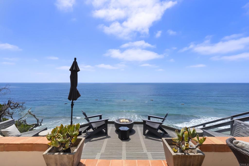 A rare chance to lease one of Neptune Avenue’s most captivating oceanfront estates. Elevated above the sand with panoramic views of the Pacific, this fully furnished coastal sanctuary offers direct beach access via private staircase and unforgettable sunsets from nearly every room. Designed for privacy and tranquility, the gated entry leads to a serene courtyard and custom Bali-style door. Inside, walls of glass blur the line between indoor luxury and outdoor beauty, with dual primary suites, flexible living spaces, and designer finishes throughout. Expansive oceanfront terraces, surfboard storage, and low-maintenance landscaping complete the experience, just moments from Leucadia’s best restaurants, shops, and cafes. Available as a short-term rental (30-day minimum). Ideal for seasonal stays, executive relocation, or a luxury coastal sabbatical.