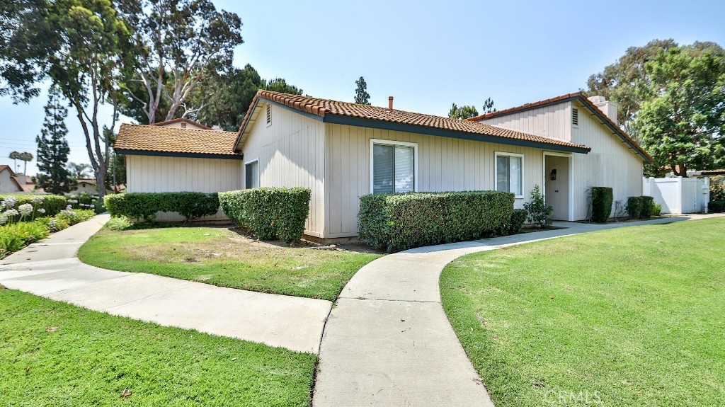 Nestled in the desirable Village Grove Community of Corona, this beautiful single-level gem offers the perfect setting to create lasting memories. With three bedrooms and two bathrooms, the home showcases a range of recent upgrades including newer windows, modern laminated flooring, quartz countertops, and refreshed kitchen cabinets. Additional features include updated appliances and a smart thermostat. The inviting living area is enhanced with recessed lighting, a ceiling fan, a cozy fireplace, and a sliding glass door that opens to a spacious, paved backyard. The primary suite boasts built-in cabinetry, a generous hallway closet, and a master bathroom with a modern vanity and walk-in shower. An oversized two-car garage provides abundant storage with built-in cabinetry and direct access to the dining area. As part of the Village Grove community, residents enjoy top-notch amenities such as a peaceful lake, clubhouse, pool, tennis courts, and basketball court—making this home a rare and charming find in one of Corona’s most sought-after neighborhoods.