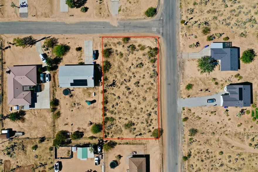 Discover the perfect canvas for your dream home on this rare corner lot in Yucca Valley. Offering approximately 0.48 acres (20,900 sq. ft.), this oversized parcel provides ample space for custom home designs, outdoor living, and more. With public water and overhead power available at the site, building your desert retreat is made simpler. Enjoy the convenience of being just minutes from Highways 62 and 247, local shopping, schools, and the world-renowned Joshua Tree National Park. Surrounded by captivating desert landscapes, this property offers both accessibility and tranquility, an ideal opportunity to create your own slice of desert paradise.