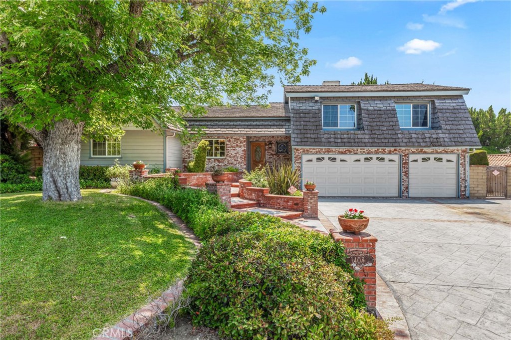 Don't miss this incredible opportunity to own this spacious home in one of West Covina’s most desirable neighborhoods - at an unbeatable new price! Recently reduced by $130,000, this spacious 4-bedroom, 3-bath home offers 2,783 square feet of versatile living space, exceptional curb appeal, and endless potential. As you arrive, you're welcomed by custom brick planters, attractive concrete work, and an oversized driveway with room for 4 cars or RV parking, all enhancing the home’s standout presence. Inside, the formal living room is located on the upper level, featuring a striking brick fireplace, soaring ceilings, and a scenic view that fills the room with natural light. Downstairs, the spacious family room offers a second brick fireplace, French doors leading to a sunroom, and a nearby 3/4 bath, making it perfect for gatherings or creating a private suite for extended family or guests. The remodeled kitchen is a true highlight—complete with a center island, built-in appliances, space for a breakfast table, and a sliding door that opens to the backyard patio, making entertaining a breeze. The primary suite, located on the upper level and set apart for privacy, features a walk-in closet plus three additional closets for ample storage. The remodeled primary bathroom boasts a newer dual-sink vanity and a large custom glass-enclosed shower. The three secondary bedrooms are spacious and share an upgraded full bath with granite countertops and dual sinks. Step outside to a large, private backyard with two levels—perfect for entertaining, relaxing, or even expanding your living space. Additional features include a 3-car garage, flexible floor plan ideal for multigenerational living or in-law quarters, and a location that can’t be beat—close to schools, shopping, restaurants, and more. Lovingly maintained by longtime owners, this home is now ready for a new chapter. With a dramatic $130,000 price reduction, this is a rare opportunity you don't want to miss - schedule your private showing today!