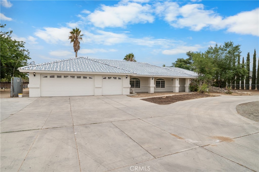 Welcome to this beautiful 4-bedroom, 3-bathroom home offering over 2,500 sq. ft. of living space PLUS an incredible 3,000 sq. ft. workshop complete with a living room/office, bathroom, and storage room – perfect for work, hobbies, or multi-use possibilities! The gourmet kitchen is a chef’s dream, featuring granite counters, a custom butler’s kitchen, bay window with extra counter space, center island with sink, roll-out drawers, wine shelf, custom range hood, and double convection oven. The spacious master suite includes a cozy sitting area and a large walk-in closet. The open, split floor plan provides flexibility with built-in hallway shelving, a built-in closet, and thoughtful touches throughout. The 4th bedroom has its own bathroom, while another bedroom includes a custom armoire – perfect for a home office setup. Step outside to your private backyard oasis with a sparkling pool, relaxing Jacuzzi and built-in BBQ. Enjoy RV access, fruit trees, and plenty of space for entertaining or unwinding. This one-of-a-kind property is ready for its new owner to bring their vision to life. With endless possibilities on an acre lot, this home is truly a rare find!