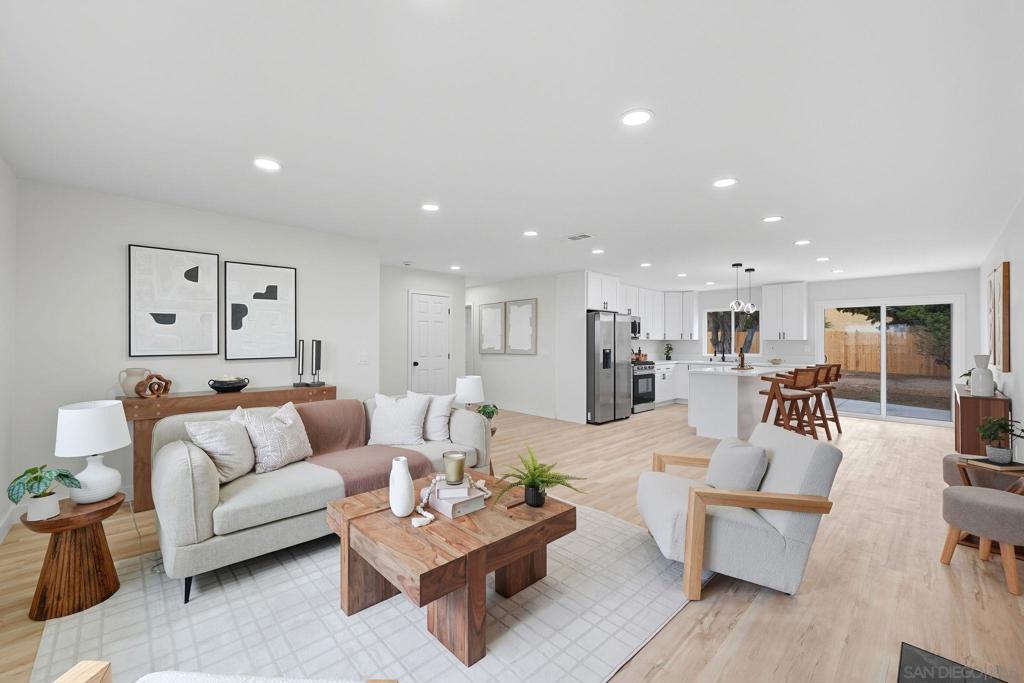 Beautifully renovated 4-bed / 2-bath single-story home with a 2-car attached garage on an oversized 8,833 sq ft lot, ADU potential, no HOA or Mello-Roos, and FHA / VA approved!!  This stunningly remodeled home is move-in ready and full of potential. Step inside to a bright, open-concept layout featuring brand-new flooring throughout and central air conditioning for year-round comfort. The inviting modern fireplace creates a warm, cozy atmosphere perfect for relaxing evenings or entertaining guests. The kitchen features all-new stainless steel appliances, quartz countertops, a large center island, and sleek contemporary cabinets. Both bathrooms are fully remodeled with quality finishes.  Large, flat backyard with R2 zoning offers endless possibilities! Explore the potential through our virtual renderings. Build an income-generating ADU or private guest house. Add a pool for the perfect outdoor retreat. Create your dream garden or entertaining space.  Located in a quiet, desirable neighborhood, this turn-key home offers convenience and lifestyle. Close to shopping, dining, schools, the Chula Vista Bayfront and the Gaylord Resort.