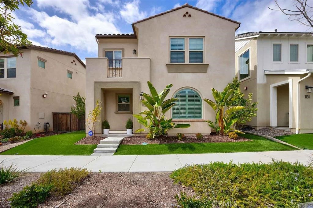 This bright and airy two-story home, built in 2018, blends contemporary design with everyday convenience. The main level offers a seamless flow between the living room, dining area, and chef-inspired kitchen, creating a warm and welcoming space. In the kitchen, you’ll find quartz countertops, sleek cabinetry, stainless steel appliances, and a large island perfect for meals and gatherings. Step right outside to a private courtyard finished with turf and stone pavers—an easy spot to enjoy morning coffee or evening downtime.
Downstairs also includes a full bedroom and bathroom, ideal for guests or multi-generational living. Upstairs, the open loft adds extra flexibility for a home office, playroom, or media lounge. The primary suite feels like a retreat, complete with a private balcony, walk-in closet, dual shower heads, and a double-sink vanity. A second side yard expands your outdoor options, whether for gardening, pets, or simply creating your own green escape.
Storage and practicality shine in the oversized 2.5-car garage, which includes built-in cabinets and overhead storage to keep everything organized.
Residents here enjoy more than just a home—they enjoy a lifestyle. The community offers resort-style perks, including a heated pool with lap lanes, a clubhouse, fitness center with classes, and a 7-acre park with playgrounds. Scenic walking paths along the canyon make it easy to stay active while soaking in the views.