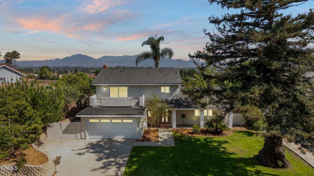 Nestled in the desirable city of Camarillo, this stunning two-story single-family residence offers 4 bedrooms, 3 bathrooms, and over a million reasons to call it home. From the moment you arrive, the double-door entry and soaring ceilings set the tone for an elegant and airy interior, enhanced by recessed lighting throughout. The formal dining area is a showpiece, featuring a centered, eye-catching chandelier and sliding glass doors that frame views of the spacious backyard. The updated kitchen is a chef's dream, showcasing marble countertops, modern cabinetry, a stylish backsplash, and a breakfast bar adorned with sleek pendant lights overlooking the inviting living room. A cozy family room with a warm fireplace and another set of sliding doors fills the space with natural light. The first floor also offers a well-appointed guest bathroom with a custom-tiled walk-in shower, a dedicated laundry room, and a generously sized bedroom perfect for guests or a home office. Upstairs, two additional bedrooms share a modern bathroom with a glass-enclosed walk-in shower. The expansive primary suite is a private sanctuary, complete with sliding doors leading to a serene balcony where you can savor your morning coffee while soaking in breathtaking mountain views. The suite also features a spacious walk-in closet and a luxurious en-suite bathroom with dual sinks and a beautifully tiled walk-in shower. This home has been thoughtfully upgraded with dual-pane windows and a new roof, offering both comfort and efficiency. The backyard is a true highlight, offering ample space for entertaining, mature fruit trees including coffee and banana, and unparalleled panoramic vistas that will make you fall in love with this property all over again. With a 2-car garage, refined finishes, and a location that balances tranquility with convenience, this Camarillo gem is ready to welcome its next chapter.