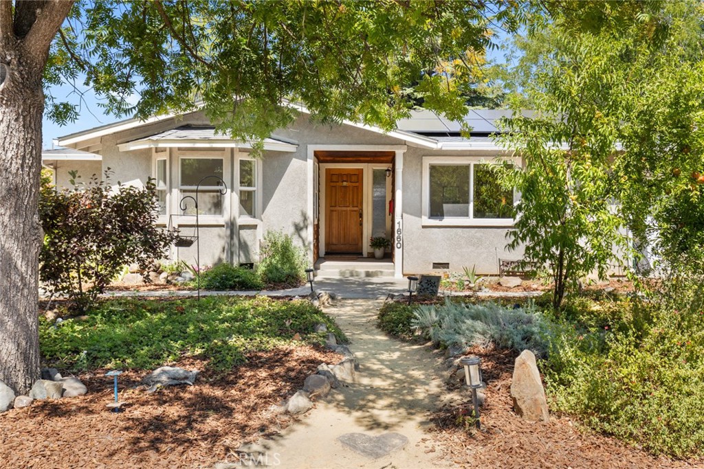 Welcome to 1660 Hooker Oak Avenue—featuring owned solar, a brand-new roof, and an ideal location in the heart of Chico, just a block from Bidwell Park and Sierra View School. This charming home sits on nearly a 1/3-acre lot and offers a 2-car attached garage, beautiful hardwood floors, and a spacious living room with a cozy pellet stove. A versatile bonus room can serve as a formal dining room, den, or home office. The enormous primary bedroom includes French doors opening to a private covered patio—your own retreat. The kitchen boasts stainless steel appliances, including a gas range, and the refrigerator is included. Additional highlights include central heat and air, indoor laundry, and an expansive backyard with a huge custom concrete patio perfect for entertaining, plus a chicken coop for fresh eggs right at home.