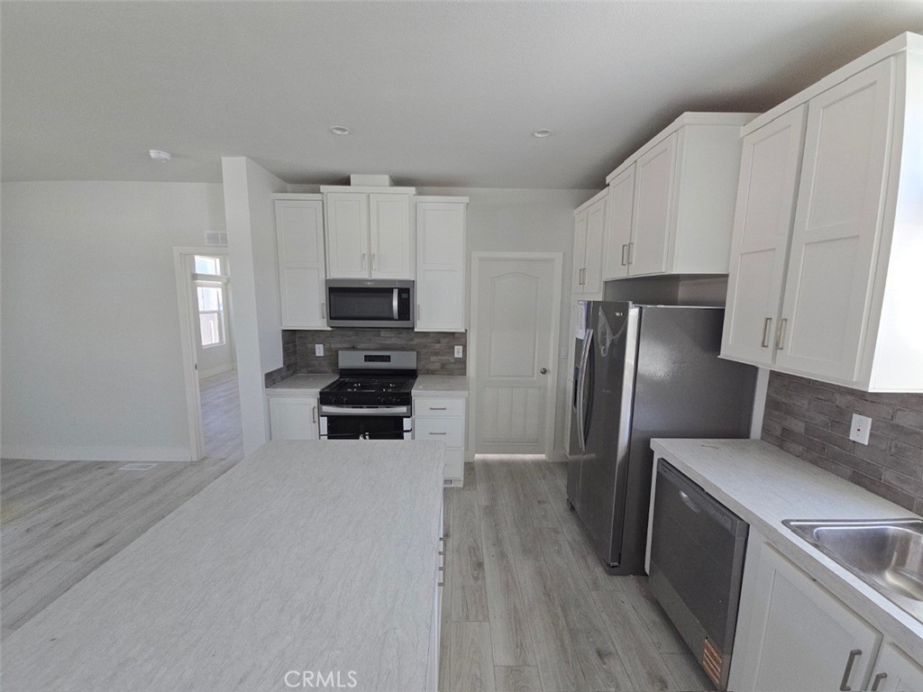 Low Space Rent-Only $800 monthly. Brand New Architectural sprawling 4 bed 3 bath manufactured home. Near 10 foot flat ceiling through entire home. Entire home encircled will upper windows just below roof line. Split floor plan, bedrooms separated by 40 feet for privacy like having two homes in one. Has a open floor plan with a Gorgeous kitchen with large soft closing cabinets and soft closing drawers And a incredible walk in pantry. Spacious dining room for large family gatherings. The Elegant living room, bathed in light. Additional 3 bedrooms and 2 baths on opposite end of home from master bedroom, offering great privacy. Huge covered porch, perfect for relaxation and entertainment. The home comes with a large enclosed side yard as well as 3 car covered parking. The community has a nice clubhouse and pool. Quiet and safe location. ALL AGE COMMUNITY with INCREDIBLY LOW SPACE RENT.