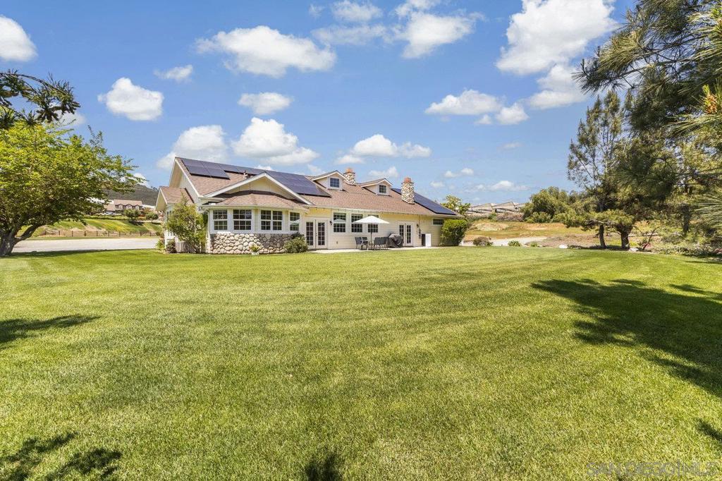 Available for the first time! Don't miss this extraordinary opportunity to own a stunning 6.26-acre estate in the highly sought-after Twin Oaks Valley area of San Marcos. Perfectly suited for equestrian enthusiasts, agricultural pursuits, or multi-generational living, this one-of-a-kind property features 3 separate homes. The main home is a custom-designed, approx 3,000-square-foot home built in 2007, featuring 3 bedrooms plus an office, 3 bathrooms, vaulted ceilings, expansive windows, and an inviting open floor plan flooded with natural light and panoramic views. The second residence is a spacious, approximately 2,000-square-foot guest home with 3 bedrooms and 2 bathrooms, complete with its own private driveway, and an expansive deck with stunning views—ideal for guests, extended family, or rental income opportunities. Additionally, there's a charming 500-square-foot secondary guest home with 1 bedroom and 1 bathroom, offering even more versatility. This meticulously maintained property has mature landscaping, lush lawns, and is fully irrigated by a private well, ensuring a vibrant landscape year-round. Electric costs are minimized with a leased solar system with 3 Tesla Powerwalls. Additional features include a large 25'x40' detached garage/workshop, a 26'x40' covered RV area, and an additional detached 18’x20’ workshop or bonus room. Fully usable acreage presents endless possibilities, featuring multiple outdoor spaces ideal for hosting events, as well as two paddocks ready for horses or livestock. Enjoy privacy and tranquility in this exceptional ranch setting, all within easy reach of equestrian facilities, local trails, and urban amenities. This incredible property truly offers everything you've been dreaming of.