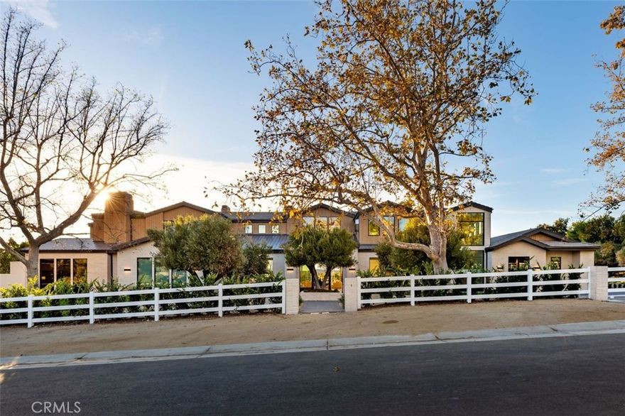 Completed in 2025, this stunning custom estate is sited in the prime Ashley Ridge section of Hidden Hills and features panoramic pastoral & sunset views! Sited on a beautiful, almost all flat 1.2-acre lot, this home offers a rare blend of modern elegance & timeless design. Spanning approximately 14,850' of luxury living space, highlights of the sunny, open floor plan include soaring ceilings & sliding walls of glass that open to the private & spacious grounds, plus a beautiful chef's kitchen with two islands & counter seating, a separate full prep kitchen, big breakfast room, spacious family room with an artistic fireplace, entertainer's lounge with wet bar, formal dining room, custom office, media room, and a truly amazing, glass encased gym with steam, sauna, indoor spa and cold plunge! There are five bedrooms in the main house, including the gorgeous primary suite with all stone bath, two superb, oversize walk-in closets and a walk-out balcony showcasing the endless sunset views. There is also a separate two bedroom and two bath guest house complete with a full kitchen, plus there is approval for a future barn if desired. The superbly private grounds offer loads of off-street parking, a sparkling pool with fountains and large adjoining spa, a full barbecue center, lush grassy areas, mature trees, and wide-open pastoral and sunset views. Located conveniently close to the highly rated public & private schools, excellent local restaurants, and the nearby beaches of Malibu, this beautifully built home has much to offer.