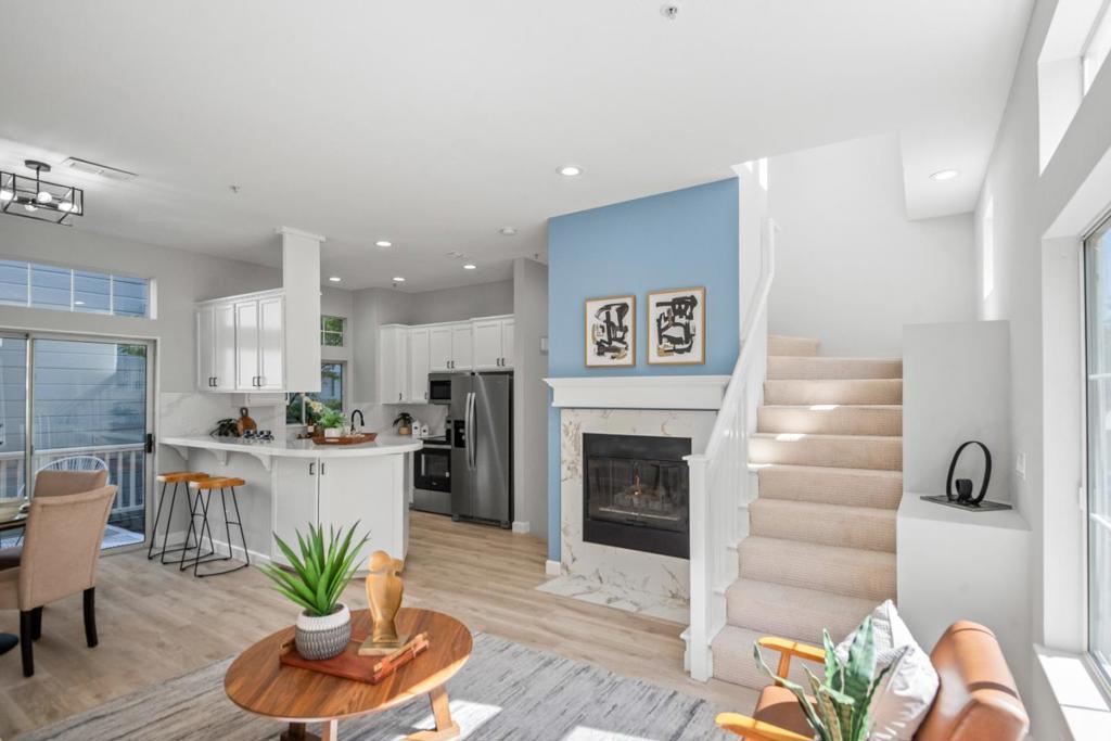 Soaring ceilings, beautifully elegant windows, & fantastic location less than two miles to Apple Spaceship Campus! Vaulted ceilings & abundant natural light set the tone for this inviting home, quietly tucked among mature redwoods in the back of a peaceful community near numerous eateries & high-end amenities. The primary suite is a true retreat, featuring one large window with rounded top that lets light stream in, large walk-in closet, & ensuite with double sinks & striking triple-window detail. The second bedroom offers direct access to a private patio with lovely fauna, irrigation system, & room for seating, ideal for relaxing mornings or a bit of fresh air throughout the day. A wide window brightens the living room, anchored by an attractive tile fireplace & opening to the private balcony. Nearby, the kitchen boasts stainless steel appliances, peninsula with seating, & passthrough to the dining area, creating an ideal setup for hosting. Additional highlights include in-unit laundry with upper storage cabinets & private attached garage with extra storage space. Plus, students have access to excellent schools in Braly Elementary, Peterson Middle, & Wilcox High (buyer to verify)!