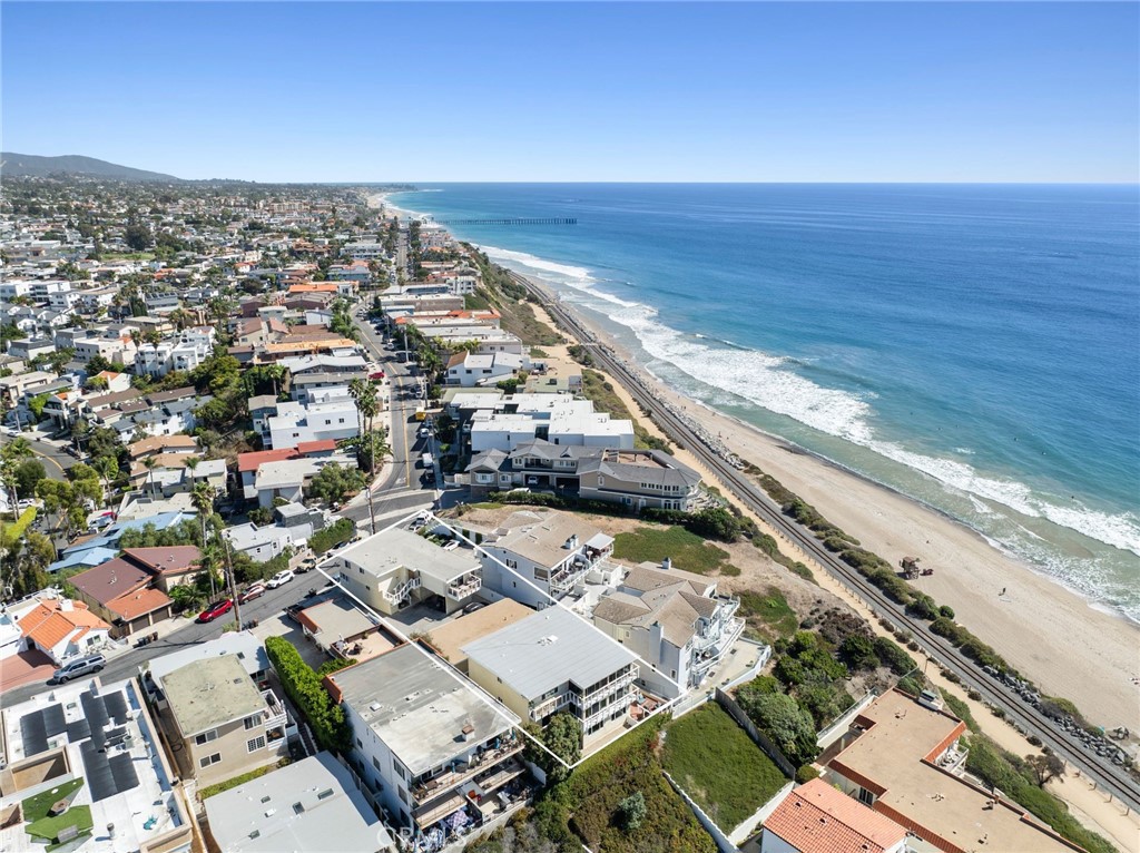 We are pleased to present the sale of 1531 Buena Vista, a stunning 5-unit multifamily property located in the City of San Clemente. The property has a favorable mix of units featuring (4) 2 bedroom / 2 bathroom units and (1) 1 bedroom / 1 bathroom unit. Each unit has been remodeled to today’s standards, boasting hard wood style flooring, recessed lighting, dual pane windows, white shaker cabinetry, quartz countertops, and stainless steel appliances. Each unit is separately metered for gas/electricity and has private balconies with jaw dropping City and Ocean views. The property offers the possibility of adding an ADU, which would amplify rental income and elevate the properties overall value. Tenants enjoy the convenience of an on- site laundry room with multiple washer/dryers as well as a community patio with breathtaking ocean views. The property offers ample parking which includes (6) single car garages and (3) additional on-site parking spaces. Tenants appreciate the close proximity to beautiful beaches, Outlets at San Clemente, Ole Hanson Beach Club, and excellent restaurants. Rarely does a property of this caliber come to market and is truly a generational asset you will want to add to your portfolio!