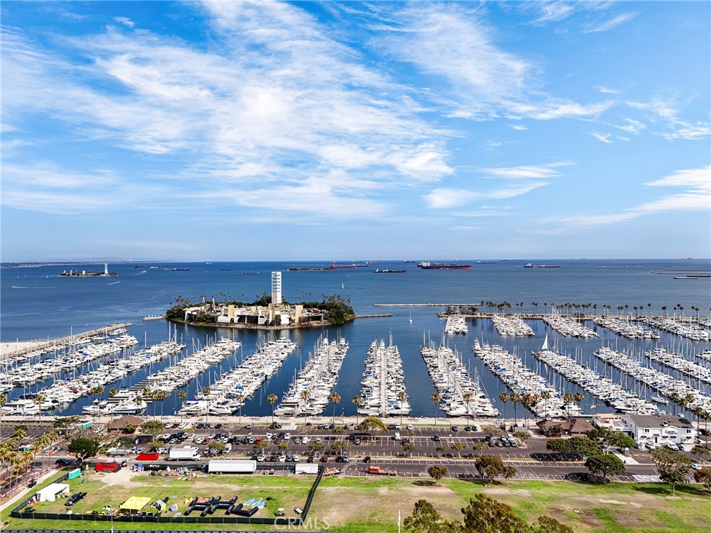 Soak in breathtaking sunset views over the Pacific Ocean from this stylish and sun-filled coastal condo! Step inside to soaring 10-foot ceilings and an abundance of natural light that fills the living area. The open-concept layout flows seamlessly into a modern kitchen, complete with granite countertops, a breakfast bar, and ample cabinetry—ideal for casual living and entertaining alike. Both bedrooms are generously sized, featuring large walk-in closets, ceiling fans, and direct access to the balcony for fresh ocean breezes. The bathrooms offer plenty of space a sleek, functional layout. Additional highlights include an in-unit laundry room, central heating and air conditioning, and thoughtful design throughout. Enjoy the ease of two deeded parking spaces in a secure, gated garage. The building is packed with premium amenities including 24-hour security and concierge service, a well-equipped fitness center, sauna, resident clubhouse, business centers with high-speed WiFi, and a sparkling pool. Located just moments from the beach, Shoreline Village, Rainbow Lagoon, The Pike Outlets, the Long Beach Grand Prix circuit, and dozens of dining and entertainment options—this is the ultimate in vibrant downtown living. Life at Aqua means luxury, convenience, and coastal charm all in one.