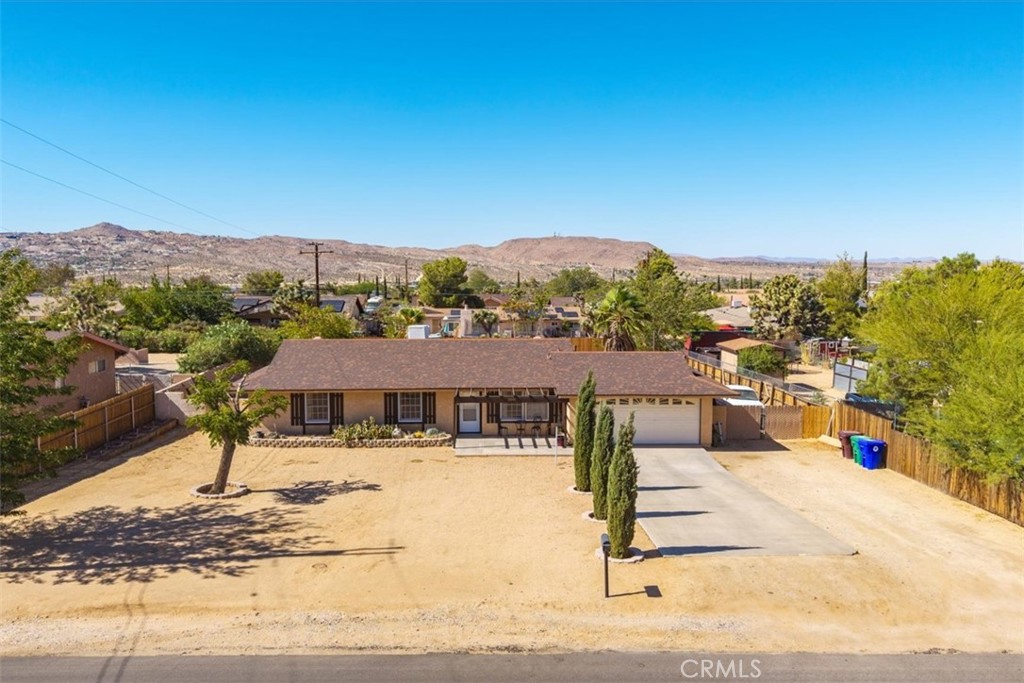 Welcome to this exceptional 3-bedroom, 2-bathroom home, complete with a versatile bonus room that can easily serve as a 4th bedroom, office, or guest space, including its own closet for added convenience. Ideally located in downtown Yucca Valley, this home offers the perfect balance of comfort, functionality, and outdoor space.
As you arrive, you'll see the wide concrete driveway and a charming exterior that sets the tone for what’s inside. The fully fenced backyard is spacious and private, offering an R.V. parking area, perfect for outdoor vehicles or anyone in need of extra storage. A covered patio just off the dining area creates a seamless indoor-outdoor flow, making it an ideal spot for entertaining guests or enjoying quiet evenings under the desert sky.
Inside, the home features a bright, open layout with tile flooring in the living room and kitchen. Recessed lighting adds a modern touch, while large windows invite in plenty of natural light throughout the day. The kitchen is equipped with natural gas appliances and offers a practical layout that connects smoothly to the dining space, great for everyday living.
Comfort is also key with this home, with both central air conditioning and a swamp cooler to keep things cool in the summer, plus efficient natural gas heating to stay warm during the winter months. It’s the kind of place that feels easy to settle into, whether you're relaxing, working from home, or hosting friends and family.
Homes like this don’t come around often, make the time to see it for yourself today. I think you will love it!