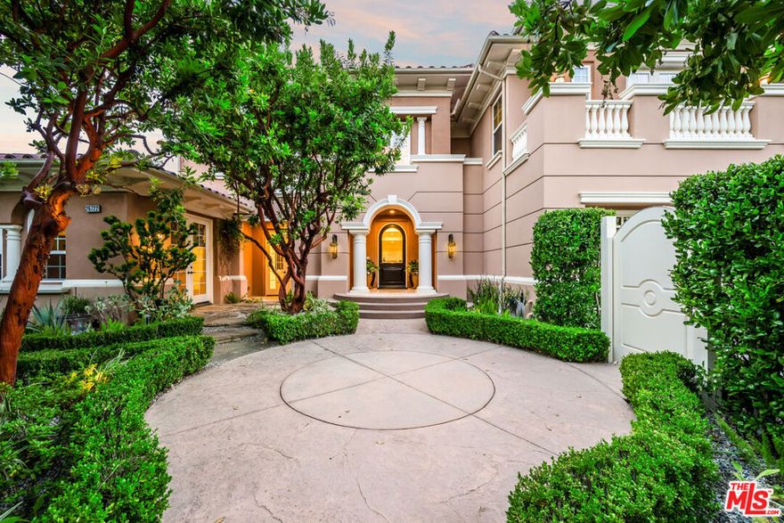 Welcome to this exquisite Mediterranean estate, privately situated within the prestigious guard-gated community of Mont Calabasas. Surrounded by lush, manicured landscaping, this timeless residence offers a harmonious blend of classic elegance and modern comfort. Upon entry, you are welcomed by a Mediterranean-inspired courtyard framed by privacy hedges and custom ironwork - an introduction to the elevated living that awaits within. Step inside to soaring ceilings, grand archways, and dramatic architectural columns framing the formal living and dining rooms. Natural light pours in through a wall of French doors, accentuating polished stone floors and curated designer finishes throughout. At the heart of the home lies the gourmet chef's kitchen - featuring high-end stainless steel appliances, custom cabinetry, an impressive center island with ample seating, and sleek granite countertops. The adjacent breakfast nook and open-concept family room offer the ideal setting for casual gatherings, seamlessly flowing out to the beautifully landscaped backyard - perfect for indoor/outdoor living. Upstairs, the spacious primary suite serves as a private retreat, featuring a cozy sitting area and a dual-aspect fireplace overlooking the serene garden sanctuary. The spa-inspired primary bathroom features a soaking tub, expansive walk-in shower, designer wallpaper/drapery, dual walk-in closets, and a dedicated fitness room. Each secondary bedroom is generously sized and includes an en-suite bathroom, ensuring privacy and comfort for family or guests. Additional amenities include maid's quarters, a bonus room that can double as an indoor theater, a home office, several private courtyards, a wet bar, and a custom wine room with ample bottle storage. The private backyard is a true resort-style oasis, showcasing a sparkling pool and spa with a baja shelf, cascading waterfalls, an elevated lounging deck, and a full outdoor dining area beneath a custom pergola. Other outdoor highlights include a built-in fire pit, custom BBQ island, and scenic walking trails that lead to multiple seating areas nestled into the hillside above the pool. Surrounded by mature landscaping, fruit trees, and intricate stonework, this tranquil setting offers exceptional privacy and a sense of escape. Priced at the lowest cost per square foot among active listings in the area, this home represents a rare value opportunity in today's market. Ideally located just minutes from upscale shopping and dining at The Commons, and situated within the award winning Las Virgenes school district, this turnkey estate exemplifies the privacy, security, and luxury that defines the Calabasas lifestyle.