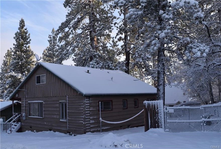 This is a really, really nice cabin.  Check out the pictures!  Great for taking the family at Christmas.  That's why the exterior pictures were taken at Christmas.  To see the snow.  This nice cabin home consists of 2 bedrooms, 2 lofts that we'll call it 4 bedrooms, and 2 bathrooms.   The interior consists of beautiful wood beamed ceilings, a vintage rock fireplace, huge living room, breakfast bar, and a very roomy kitchen. There's also a covered front deck, covered rear porch, and a large fenced backyard.  We are looking to deal and will respond quickly to all offers!!  Thank you!!!