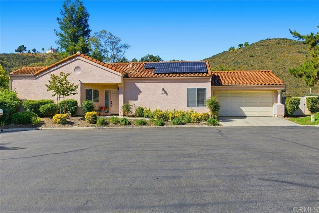 Perched at the very top of the hill in the sought-after Woodridge community, located in Northwest Escondido, this single-level home offers a rare combination of privacy, space, and stunning natural surroundings. Set on a generous 7,622 sq ft lot, the property opens up to wide open space and mountain views — with no neighbors behind and only one to the side. It’s the perfect blend of peaceful and convenient living. Inside, you’ll find 2 bedrooms and 2 full baths across 1,310 sq ft of comfortable space. The open kitchen is inviting and functional — nicely updated and ideal for everyday living. The second bedroom is impressively large, offering great flexibility for guests, a home office, or creative space. Other upgrades include owned solar and a new HVAC system. The oversized two-car garage provides extra space for storage or a workbench, and there’s plenty of street parking for visitors. Enjoy the low-maintenance yard, with much of it maintained by the HOA, and take advantage of the community pool and beautifully kept common areas. Despite the peaceful, tucked-away feel, you’re only minutes from major shopping and dining — giving you the best of both worlds. Whether you’re looking for quiet mornings with mountain views or a home that simply feels like your own private retreat, this Woodridge gem delivers it all.